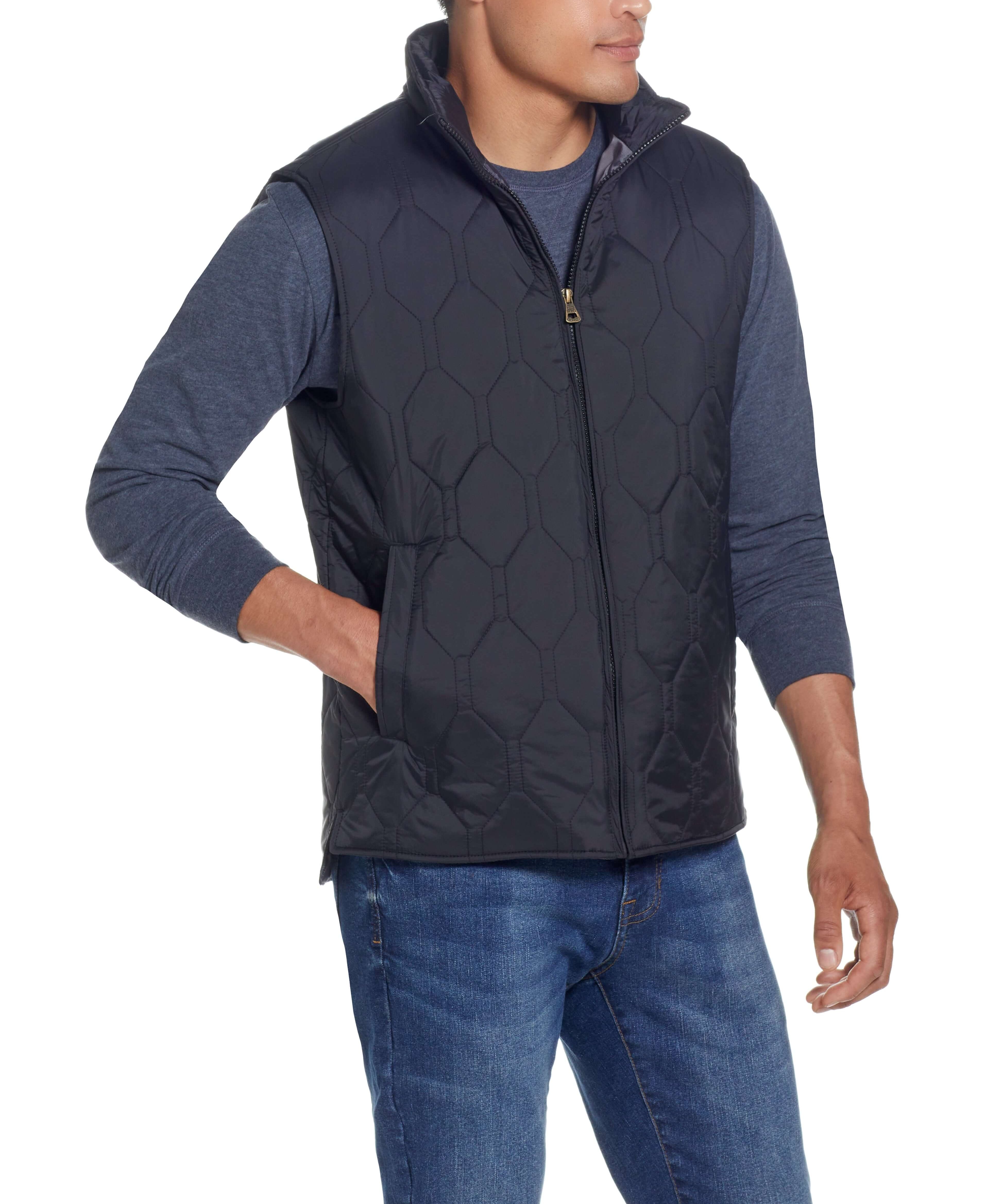 Model wearing HEXAGON QUILTED LIGHTWEIGHT VEST in BLACK with front zipper, mock-neck, and two side pockets.