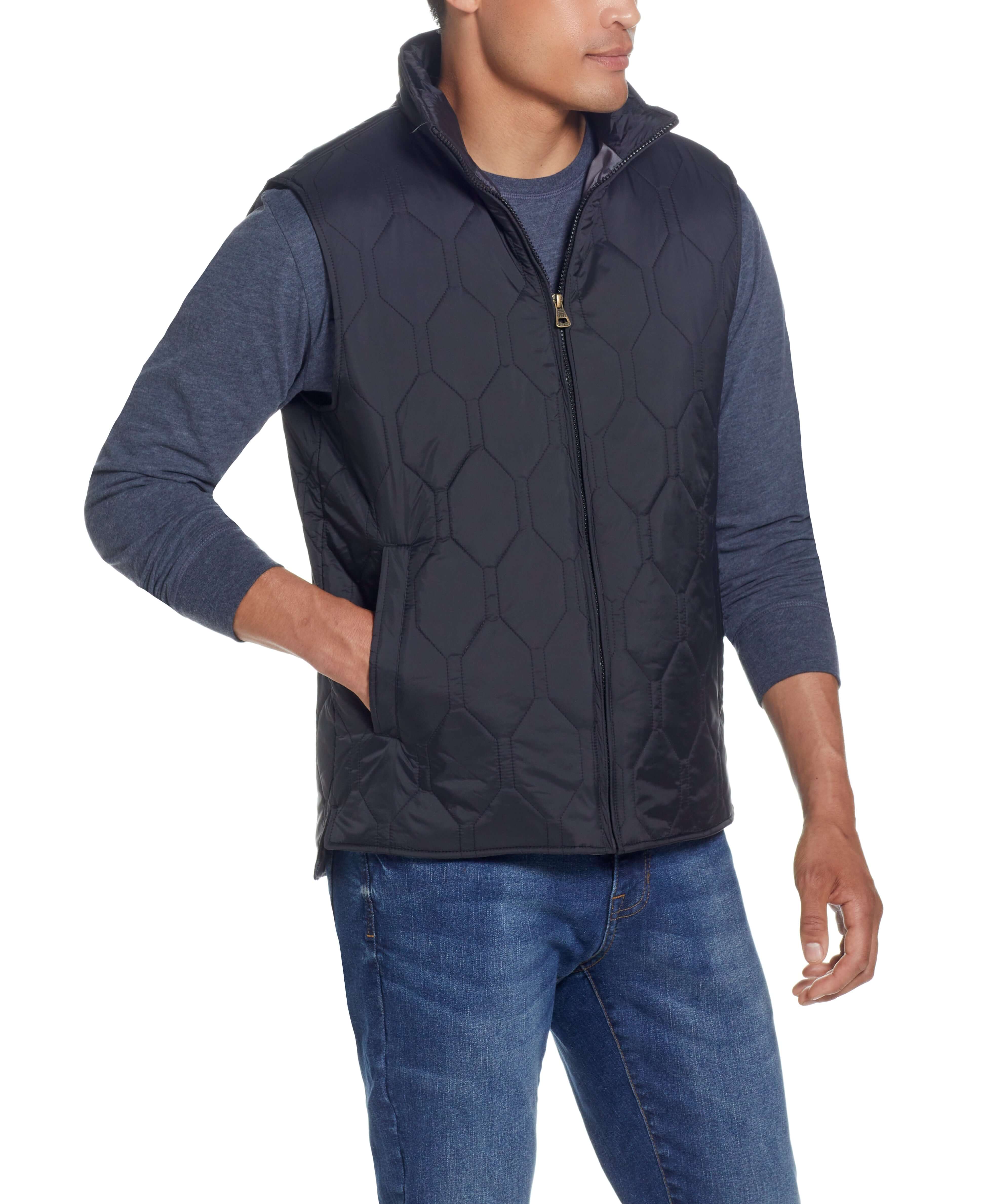 Model wearing HEXAGON QUILTED LIGHTWEIGHT VEST in BLACK with front zipper, mock-neck, and two side pockets.