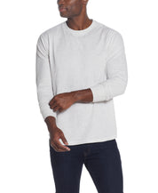 L/S BRUSHED JERSEY CREW in OATMEAL worn by a man, showcasing a relaxed fit and long sleeves.
