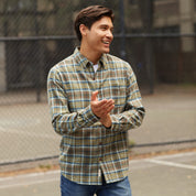 Model wearing ANTIQUE FLANNEL SHIRT in FENNEL, featuring a relaxed fit and button-down style, outdoors.