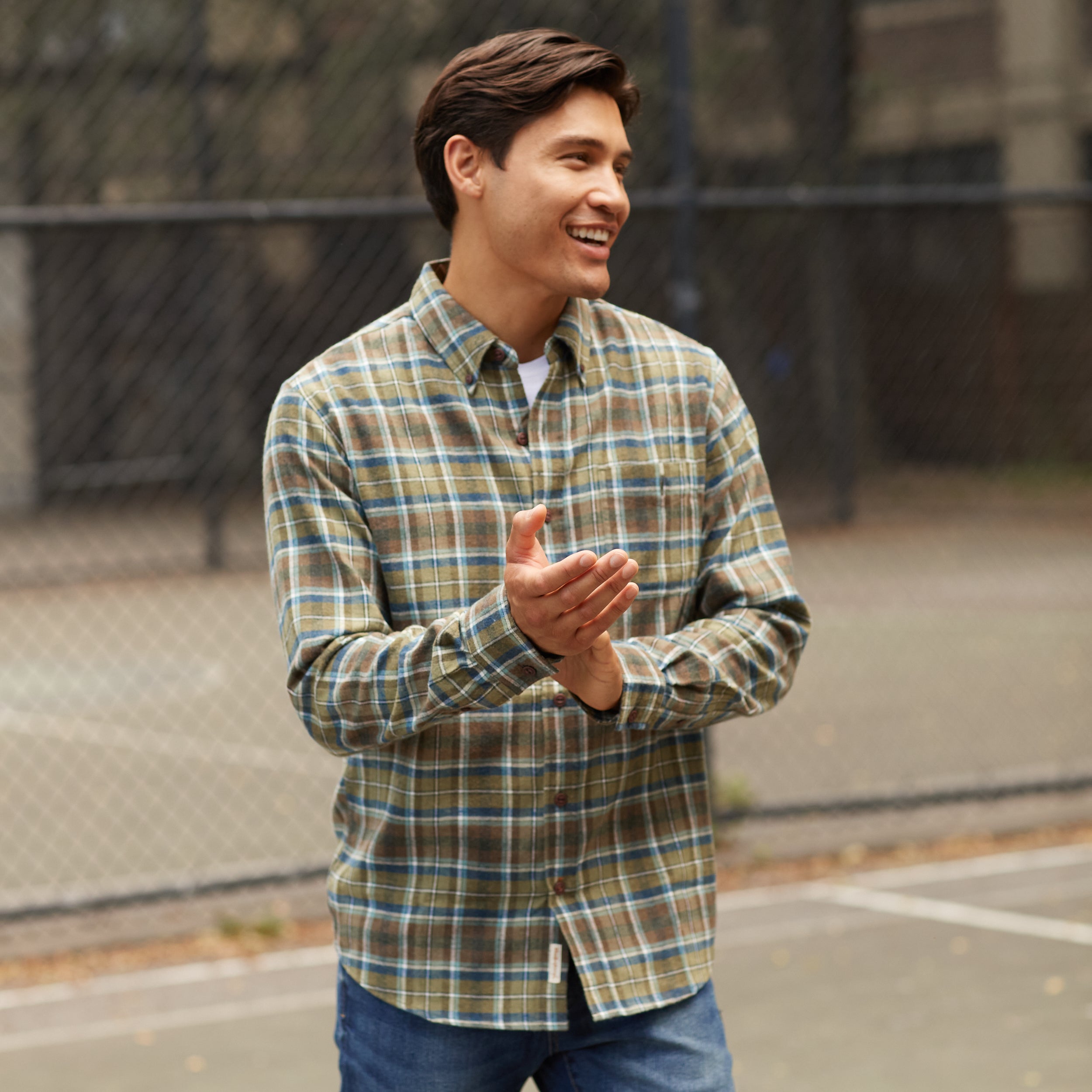 Model wearing ANTIQUE FLANNEL SHIRT in FENNEL, featuring a relaxed fit and button-down style, outdoors.