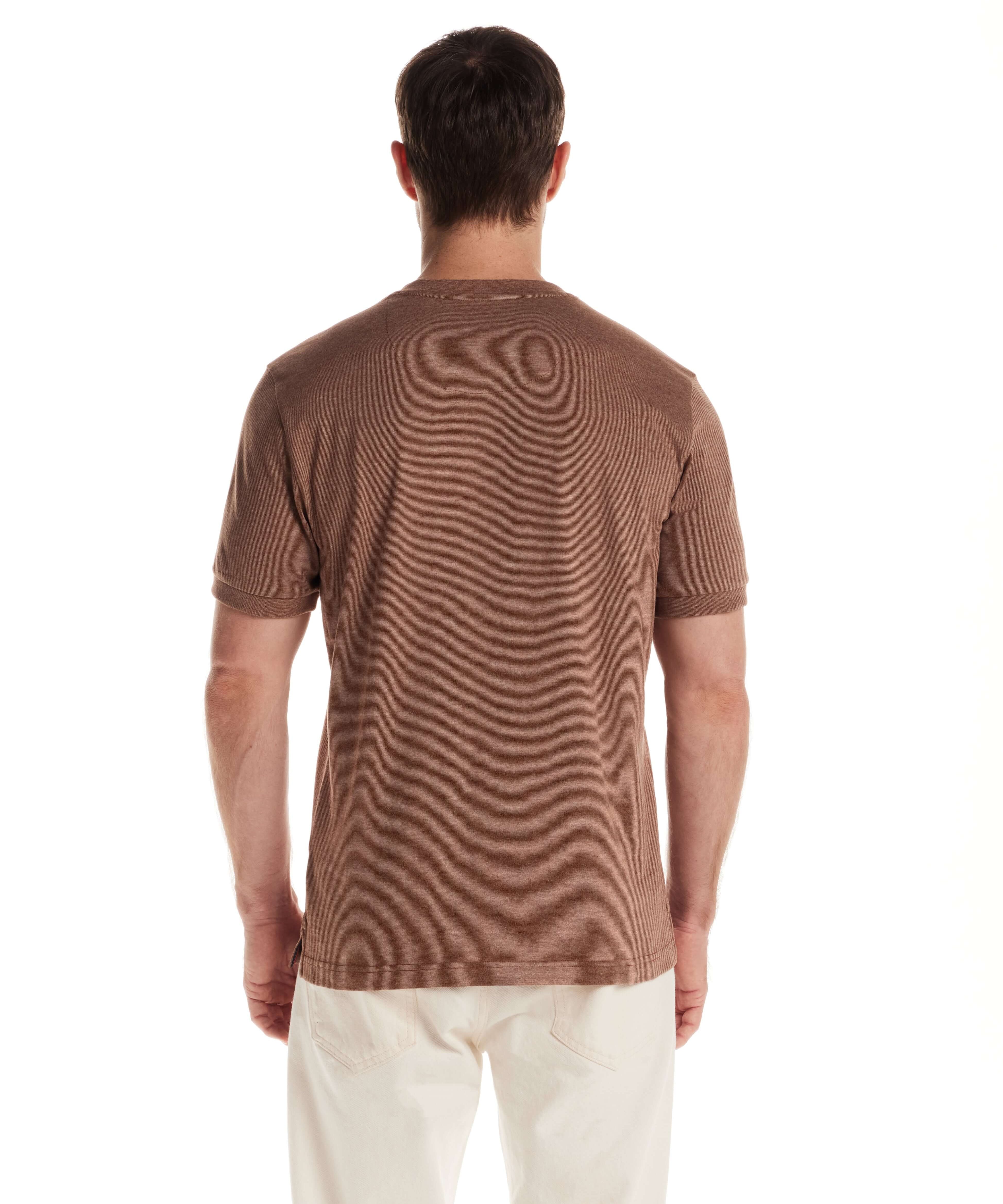 Model showcasing the back view of a short sleeve microstripe henley shirt in cappuccino color.