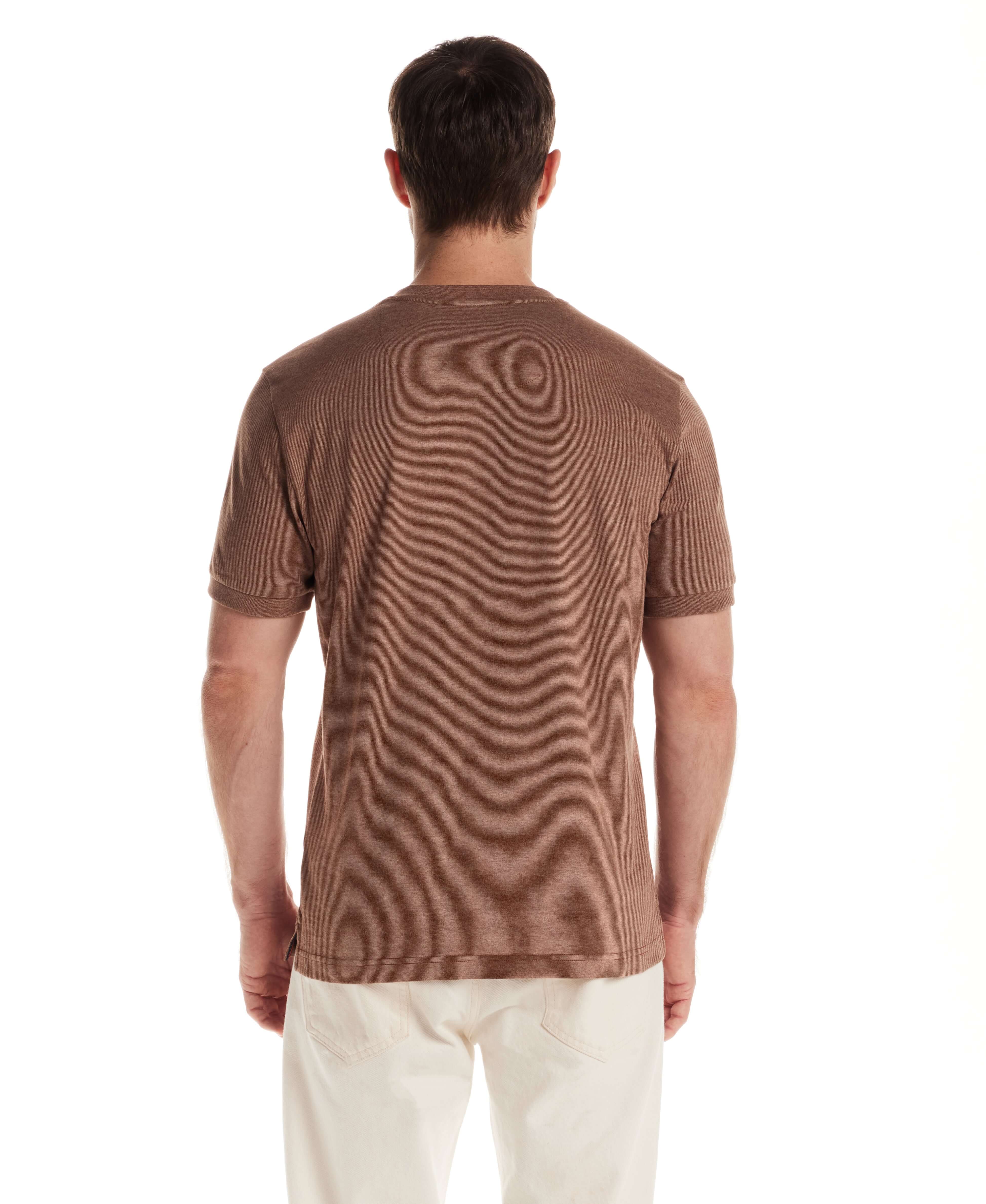 Model showcasing the back view of a short sleeve microstripe henley shirt in cappuccino color.