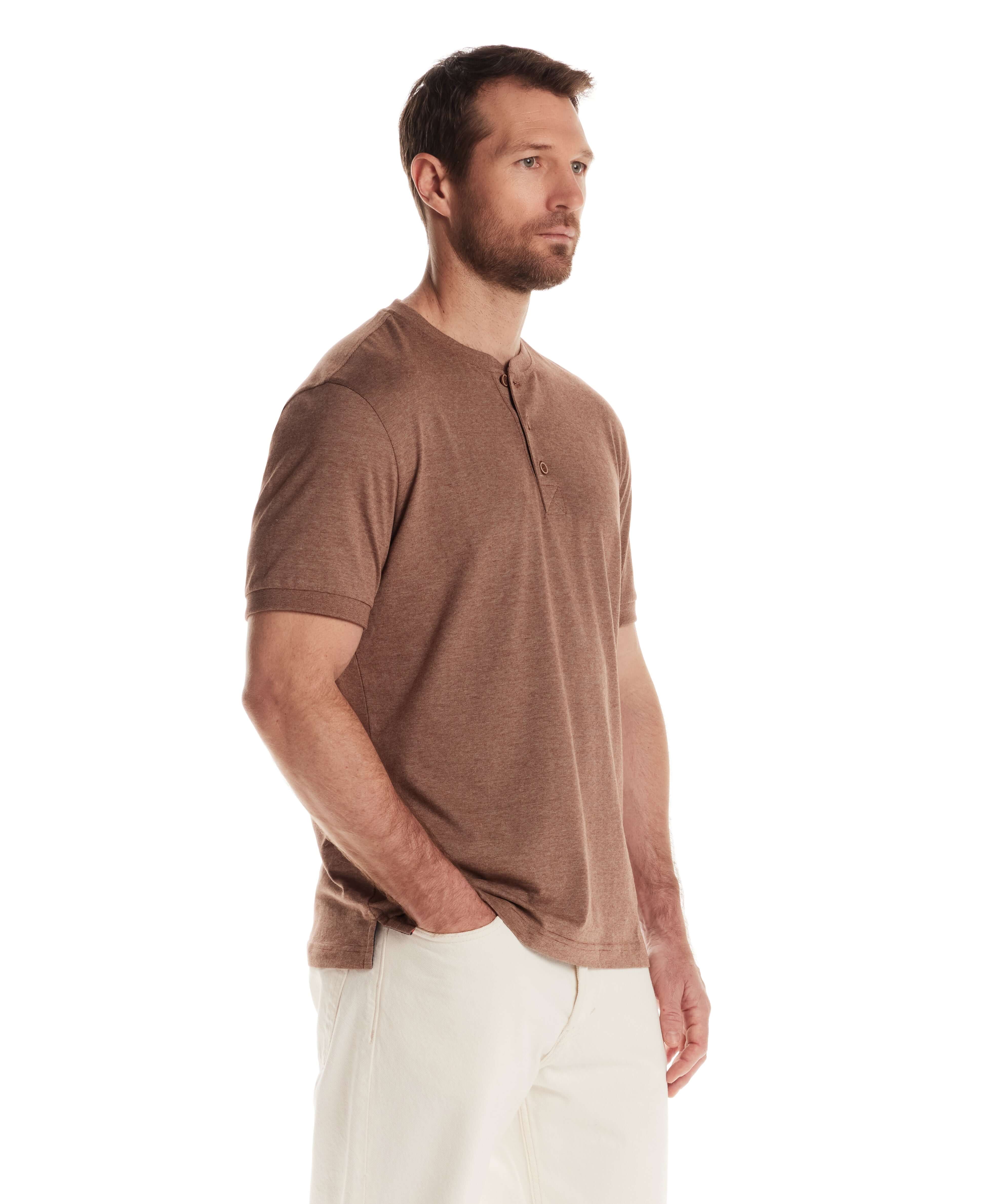 Man wearing a short sleeve microstripe henley shirt in cappuccino color, featuring a ribbed collar and a 3-button placket.