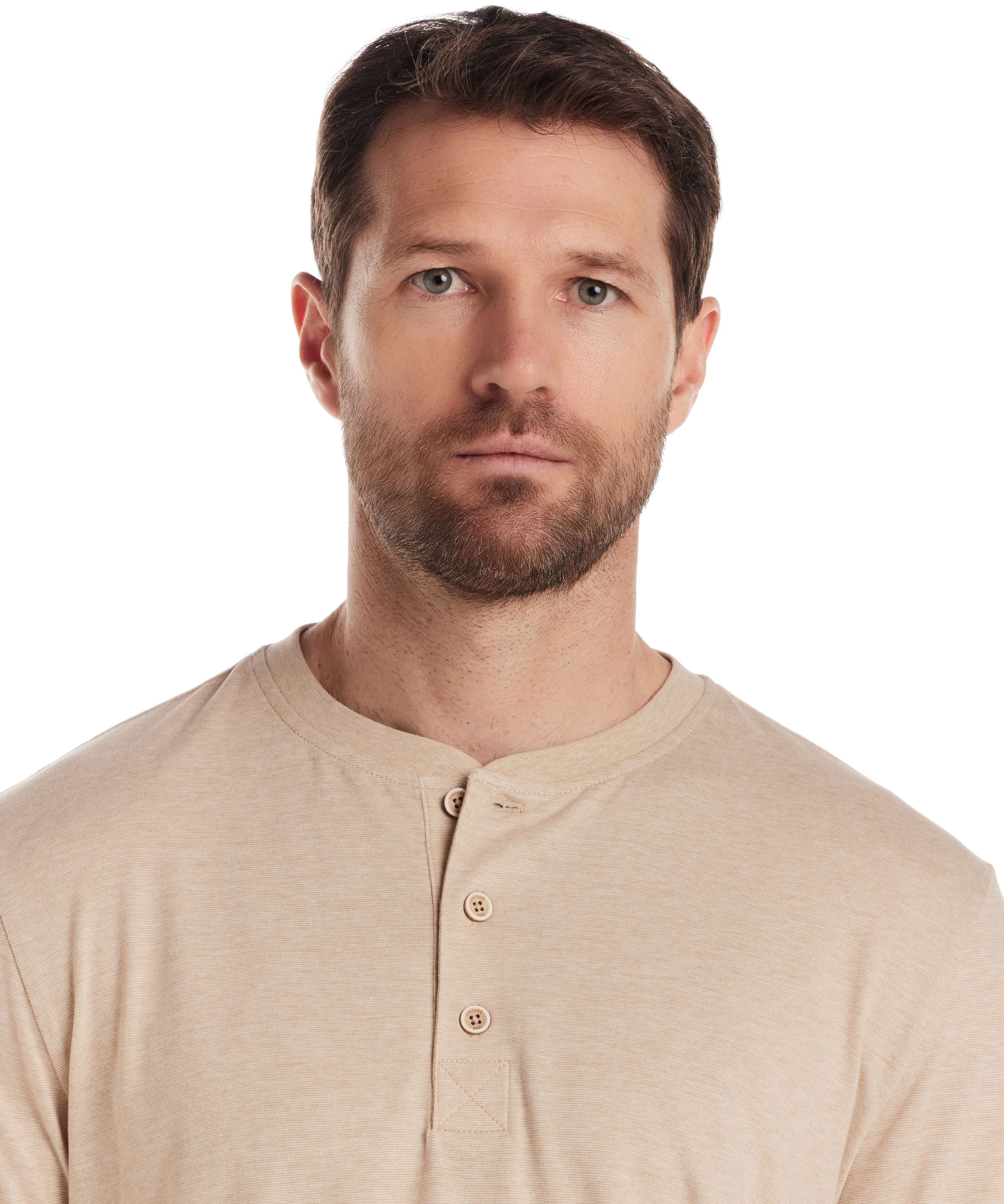 Man wearing short sleeve microstripe henley shirt in natural color, featuring a ribbed collar and button placket.