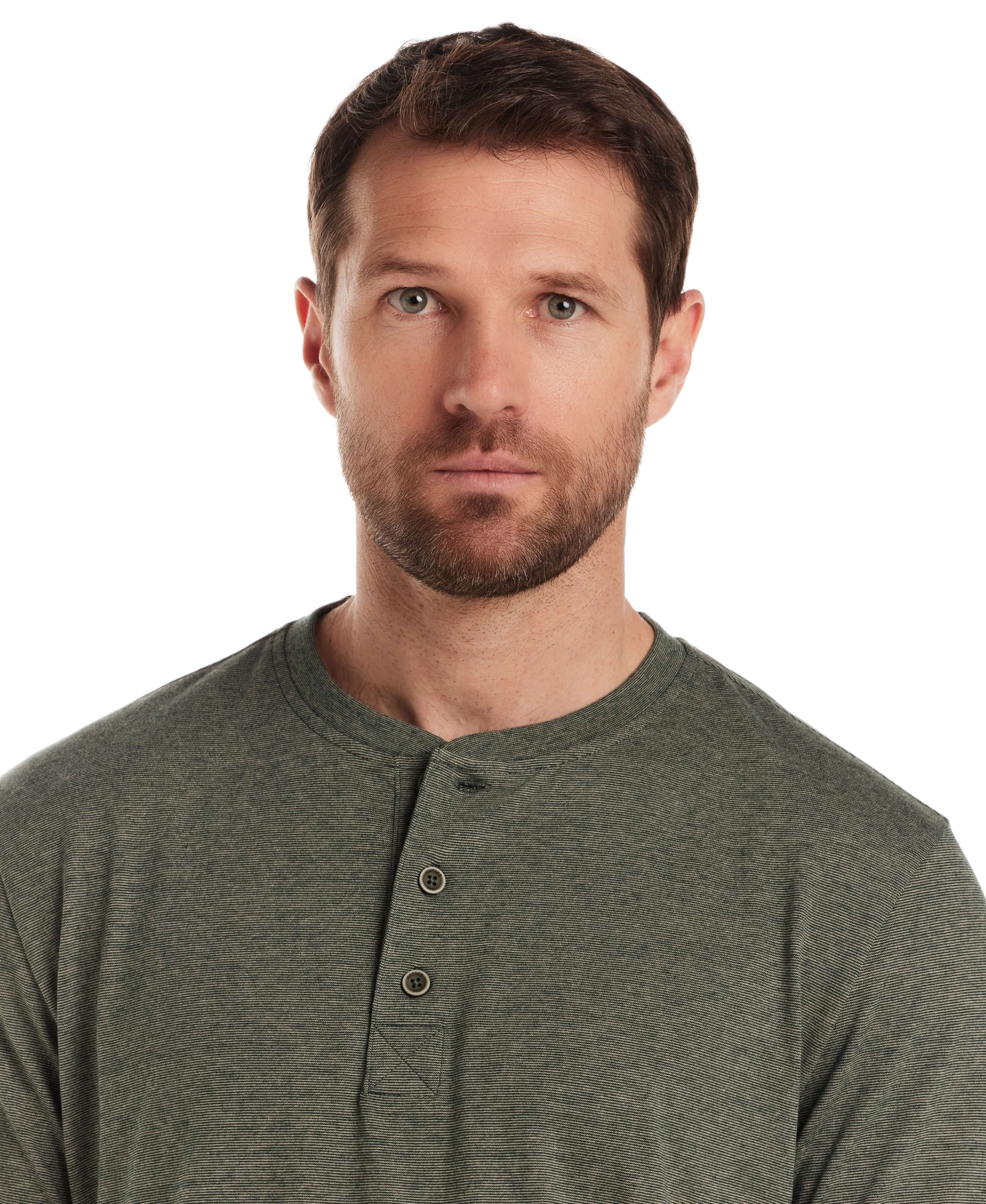 Man wearing a short sleeve microstripe henley in pine, featuring a ribbed collar and button placket.