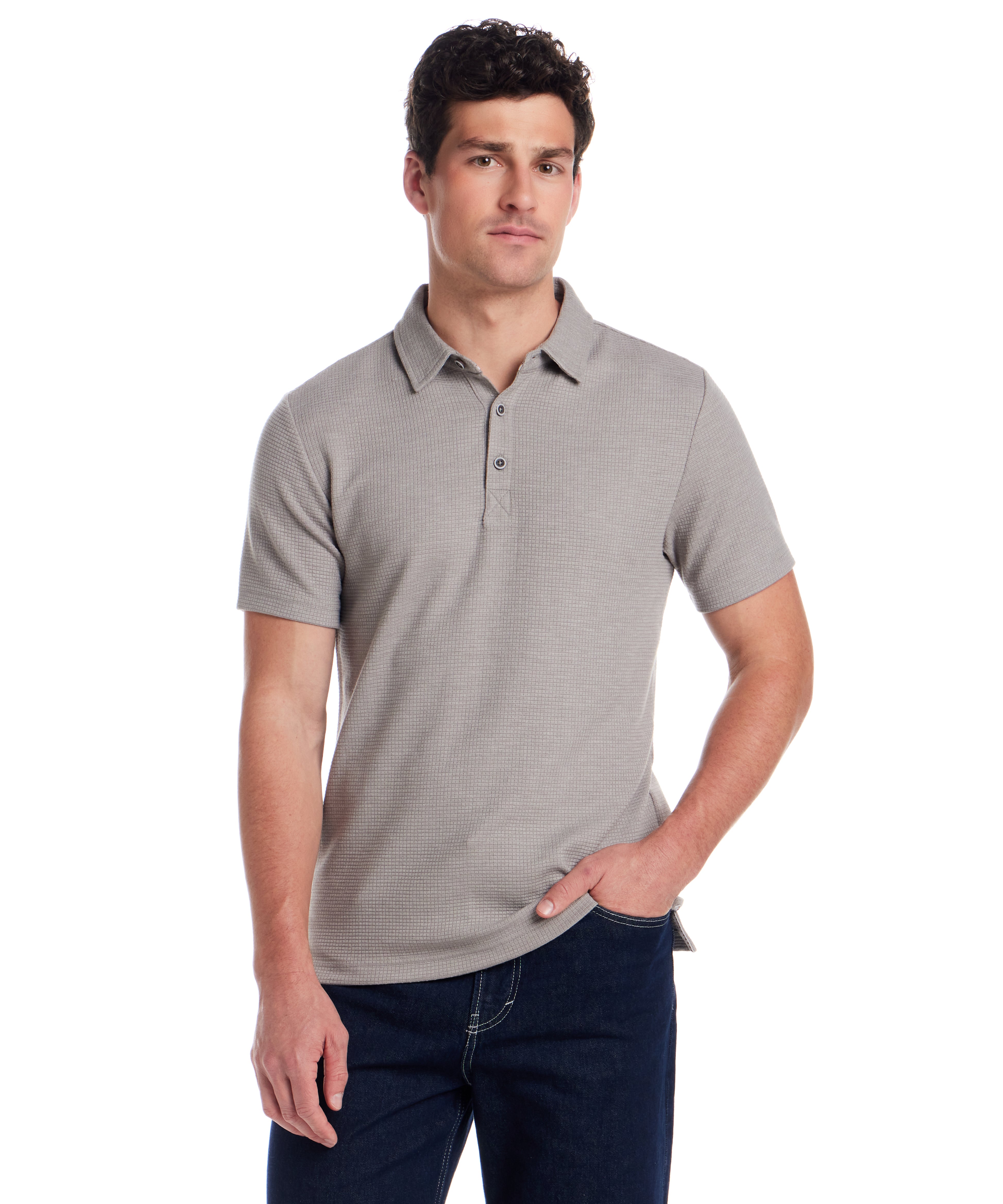 Man wearing a short sleeve stretch waffle polo in Ultimate Grey, featuring a three-button placket and clean collar.