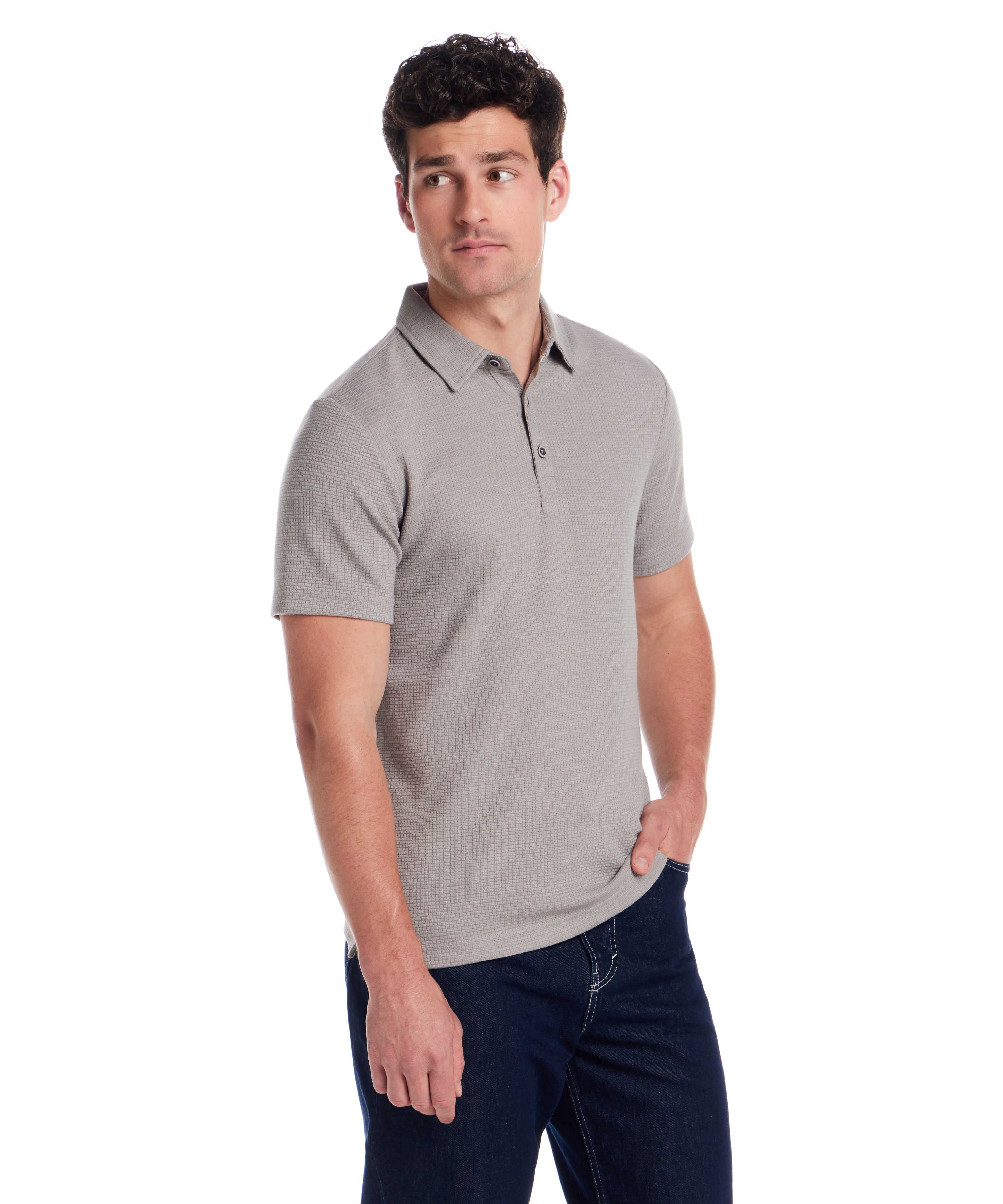 Man wearing a short sleeve stretch waffle polo in Ultimate Grey, showcasing comfort and casual style.