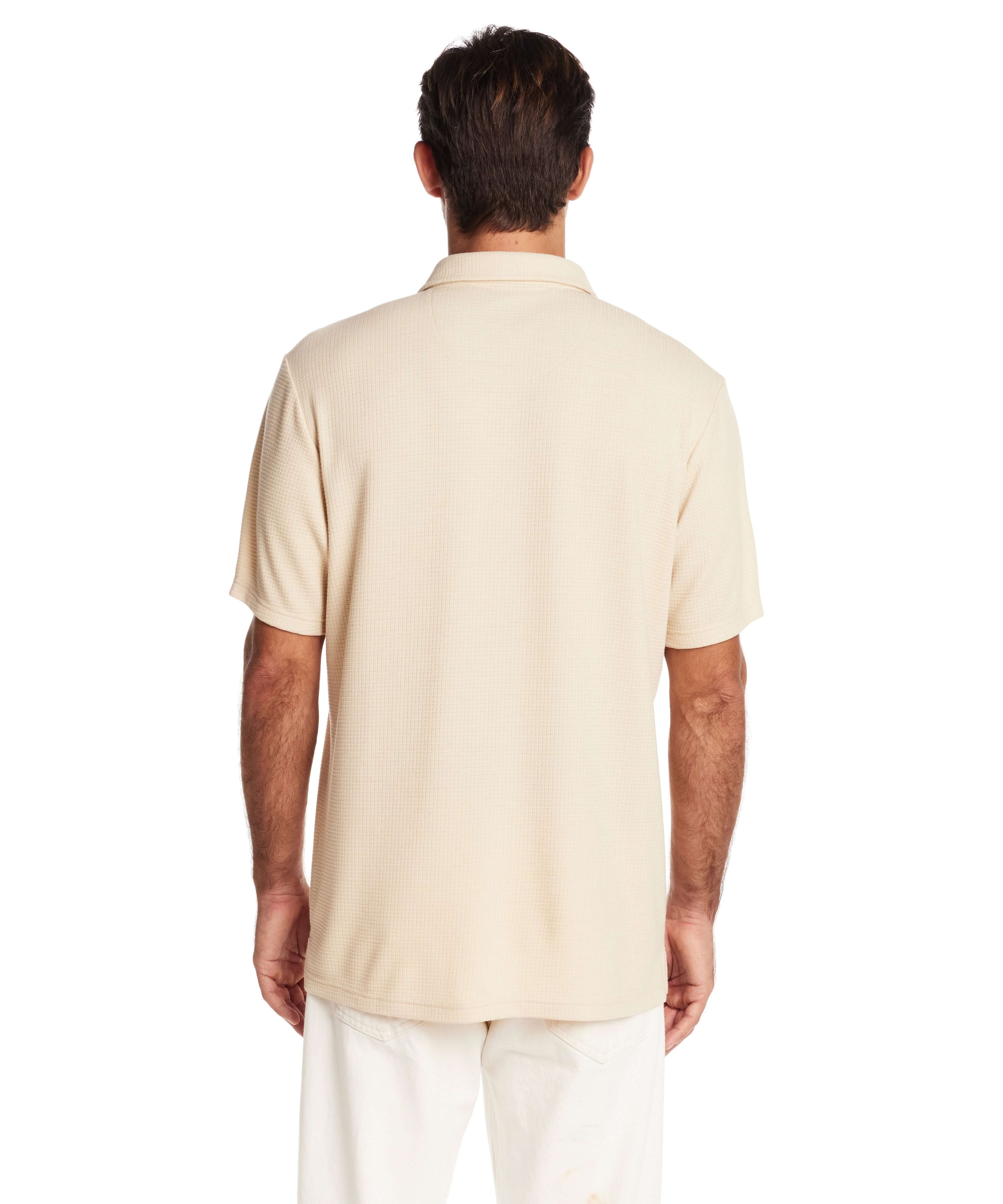 Back view of a man in a natural short sleeve waffle coat tee, showcasing its relaxed fit and soft texture.