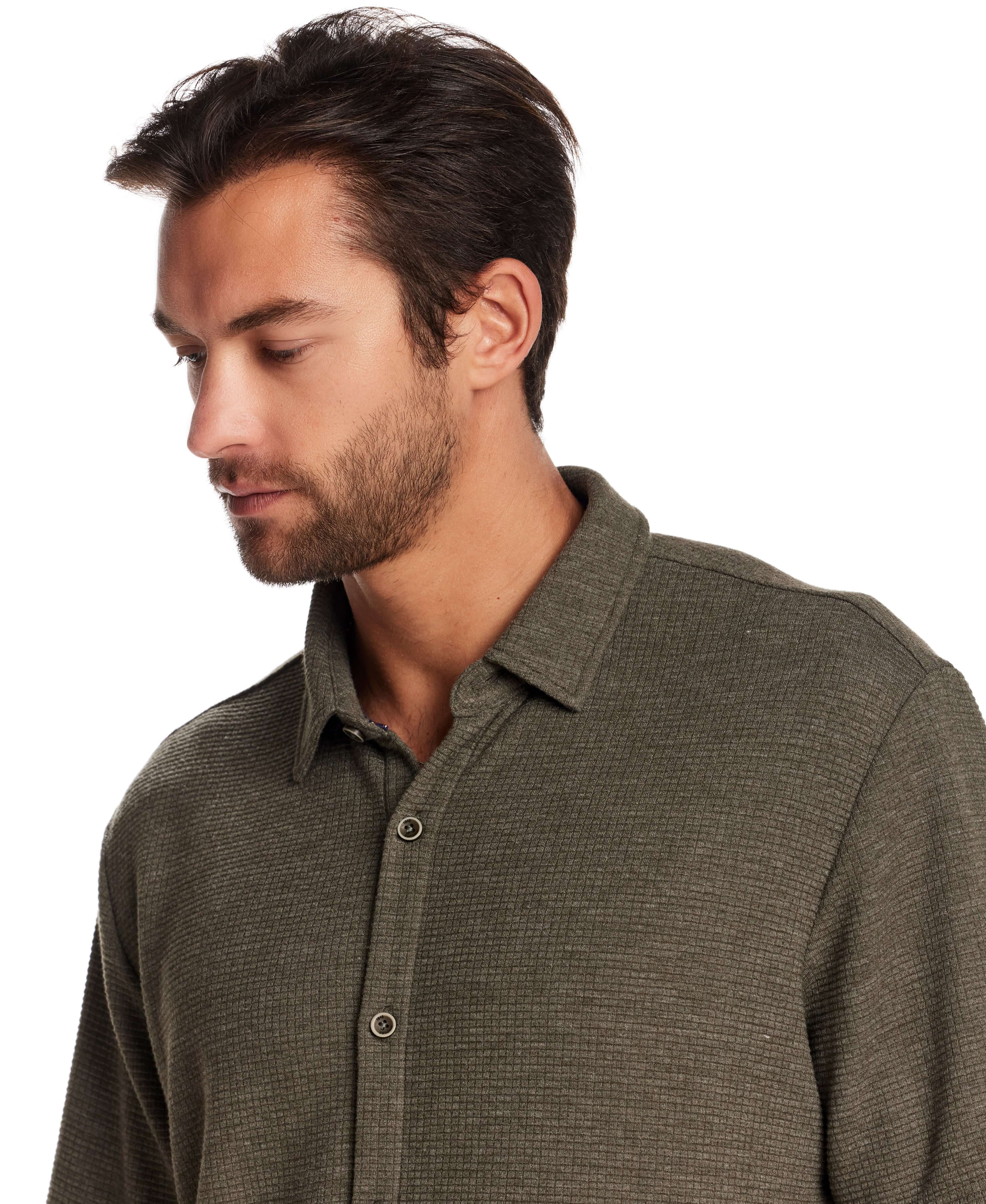 Man modeling a short sleeve waffle coat front tee in olive heather, showcasing the relaxed fit and button front detail.