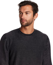 Model wearing a Twill Stonewash Sweater in Meteorite, showcasing its classic roll-neck design and textured knit.