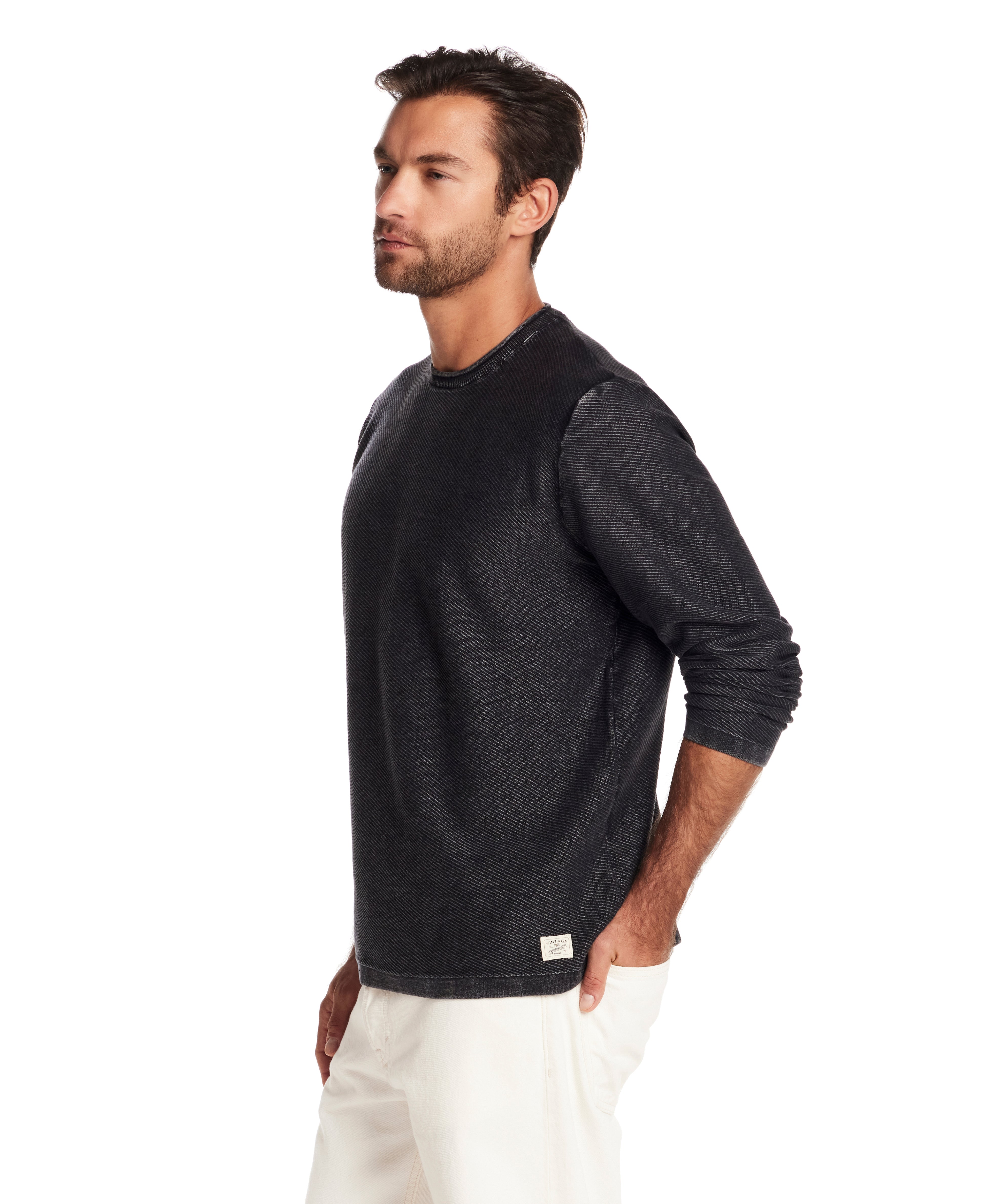 Model wearing a Twill Stonewash Sweater in Meteorite, showcasing its classic roll-neck design and relaxed fit.