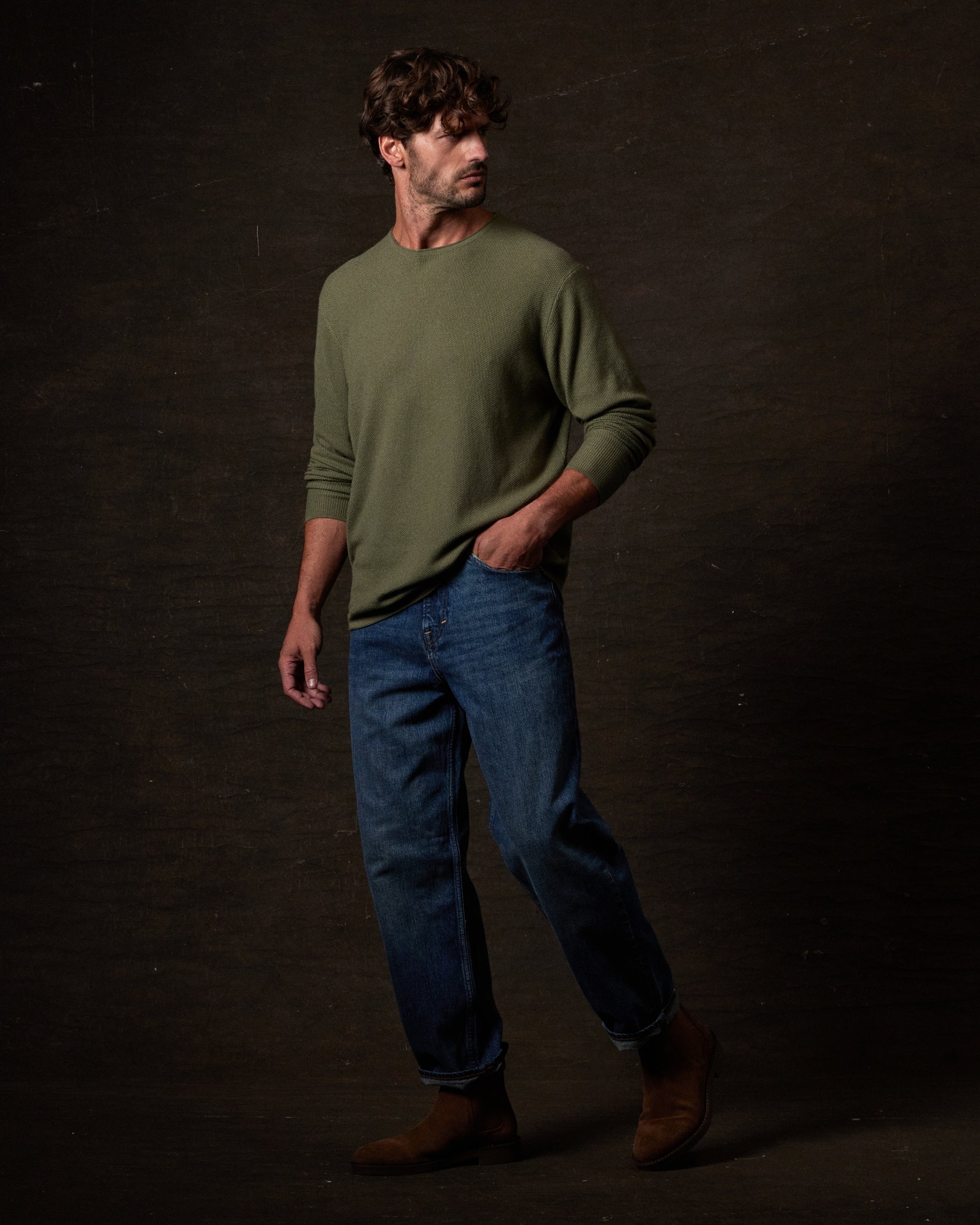 Textured Roll Neck Sweater in Tea Leaf worn by a model with jeans in a studio setting.