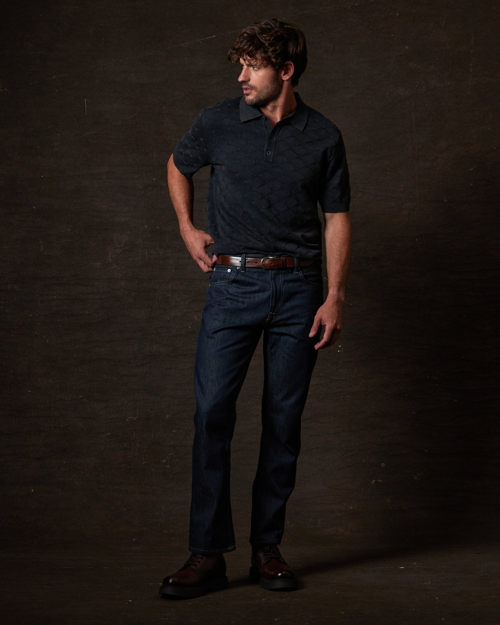 Diamond Sweater Polo in Black worn with jeans, showcasing a classic tailored fit and vintage-inspired style.