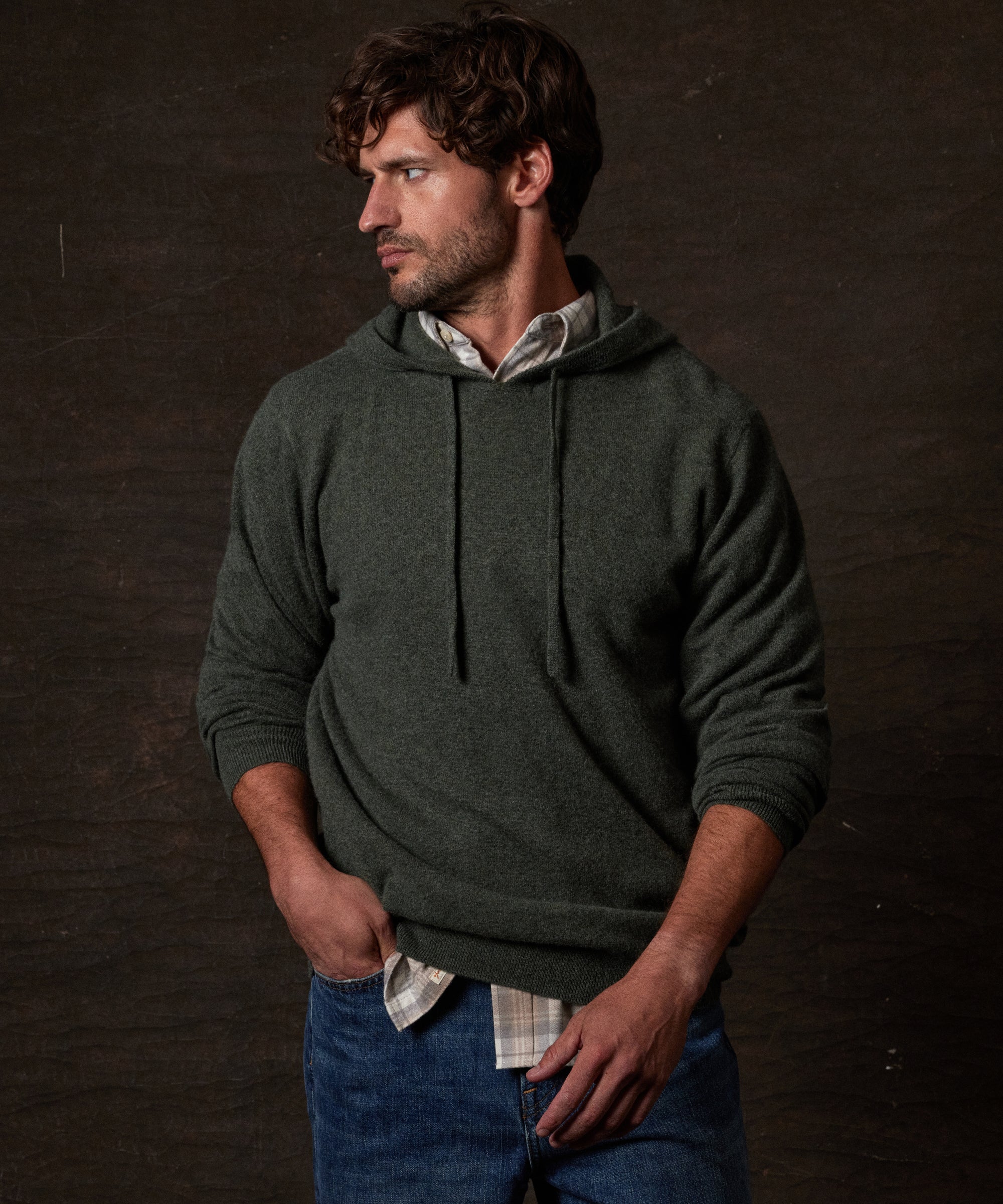S SOLID HOODIE in FOREST GREEN worn by a man, showcasing its luxurious fabric and relaxed fit.