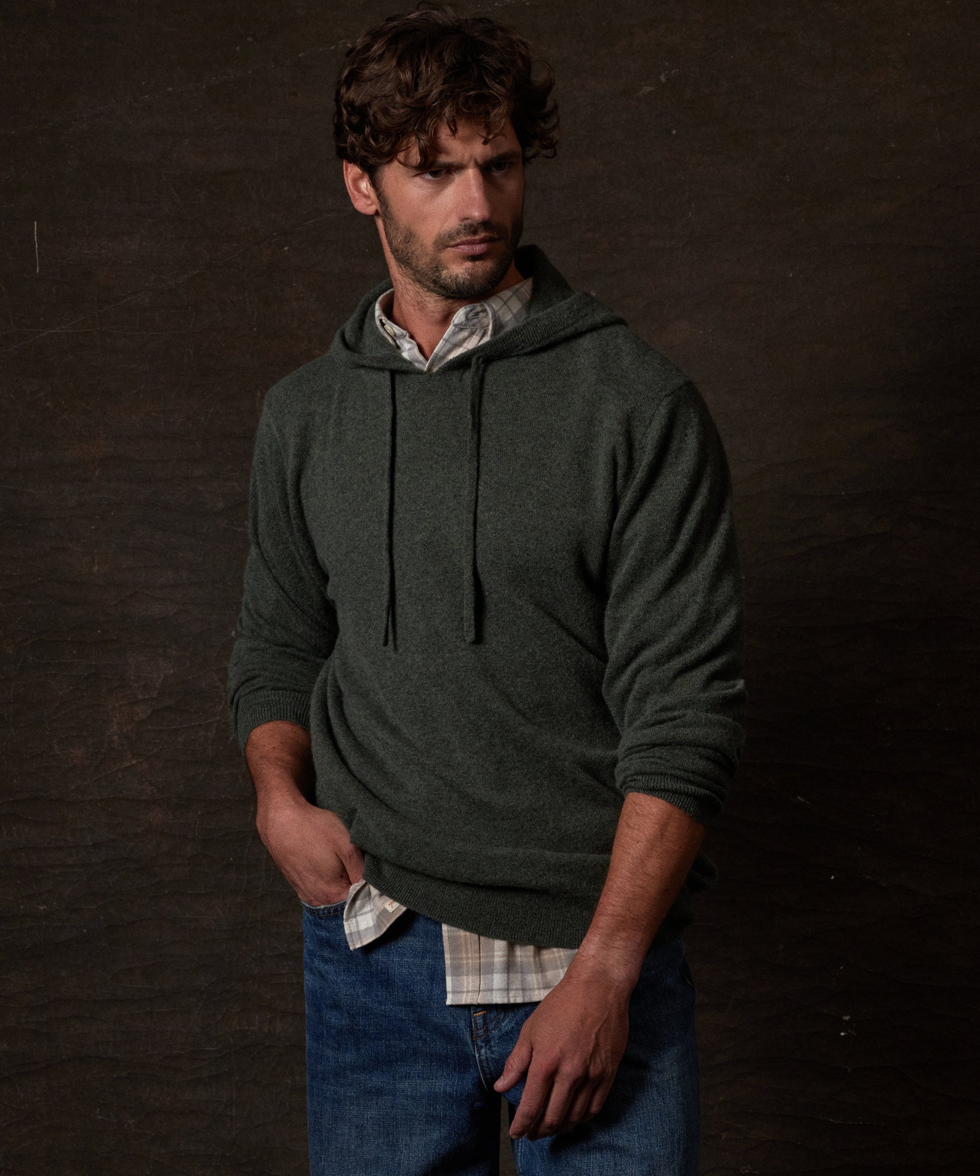 S SOLID HOODIE in FOREST GREEN displayed on a model, showcasing its elegant design and cozy fit.