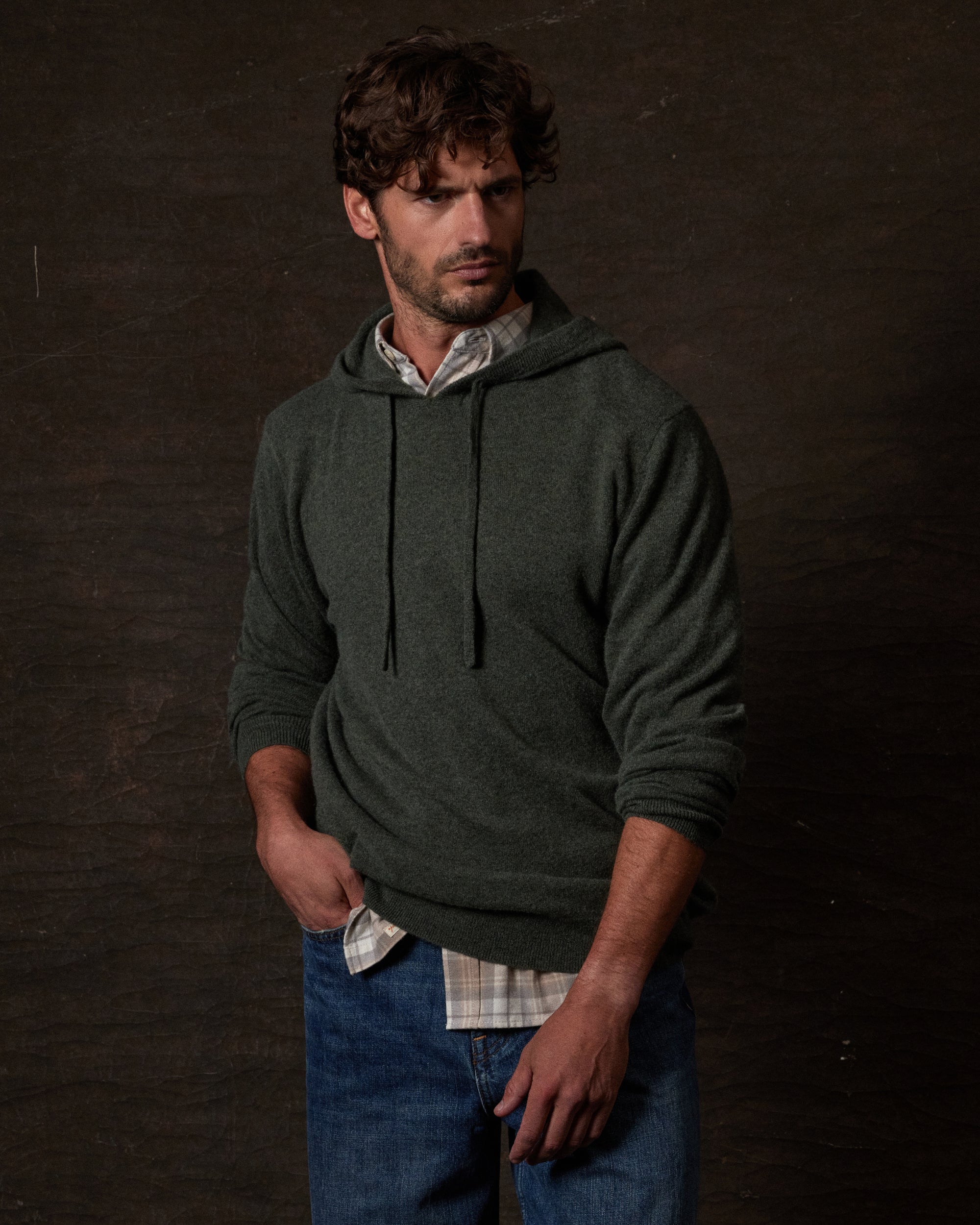 CASHMERE L/S SOLID HOODIE in FOREST GREEN displayed on a model, showcasing its elegant design and cozy fit.