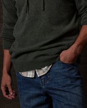 CASHMERE L/S SOLID HOODIE in FOREST GREEN worn over a checked shirt, highlighting its luxurious texture and style.