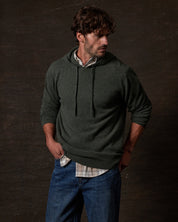 CASHMERE L/S SOLID HOODIE in FOREST GREEN worn by a model, showcasing soft cashmere fabric.