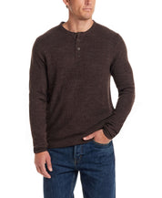 Man wearing a chocolate torte soft touch vertical stitch sweater with a four-button placket, paired with denim jeans.