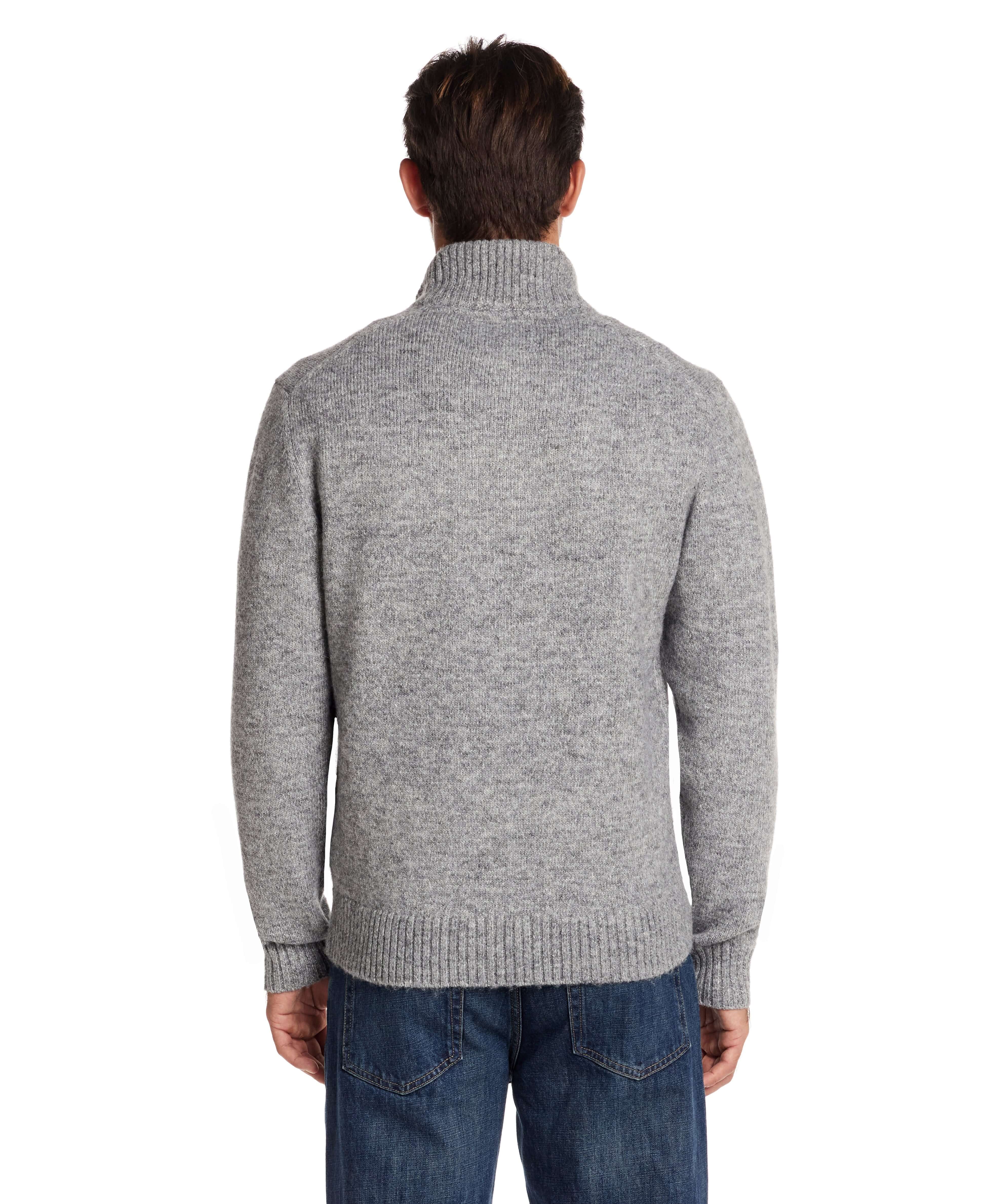 Back view of a man wearing a fuzzy grey quarter zip sweater with a mock neck and ribbed cuffs.
