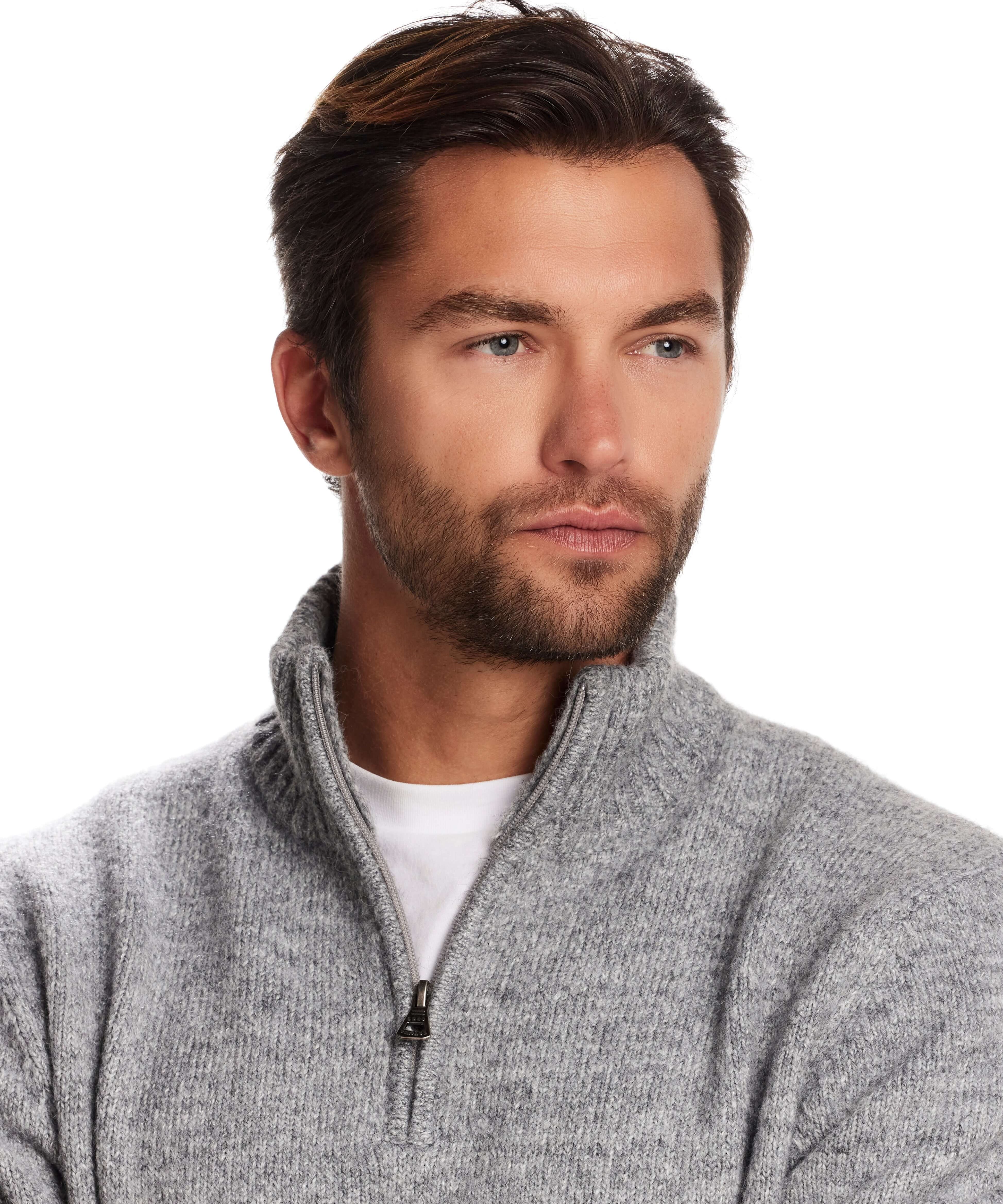 Man wearing a fuzzy quarter zip sweater in grey with a mock neck, showcasing a modern alpine layering style.