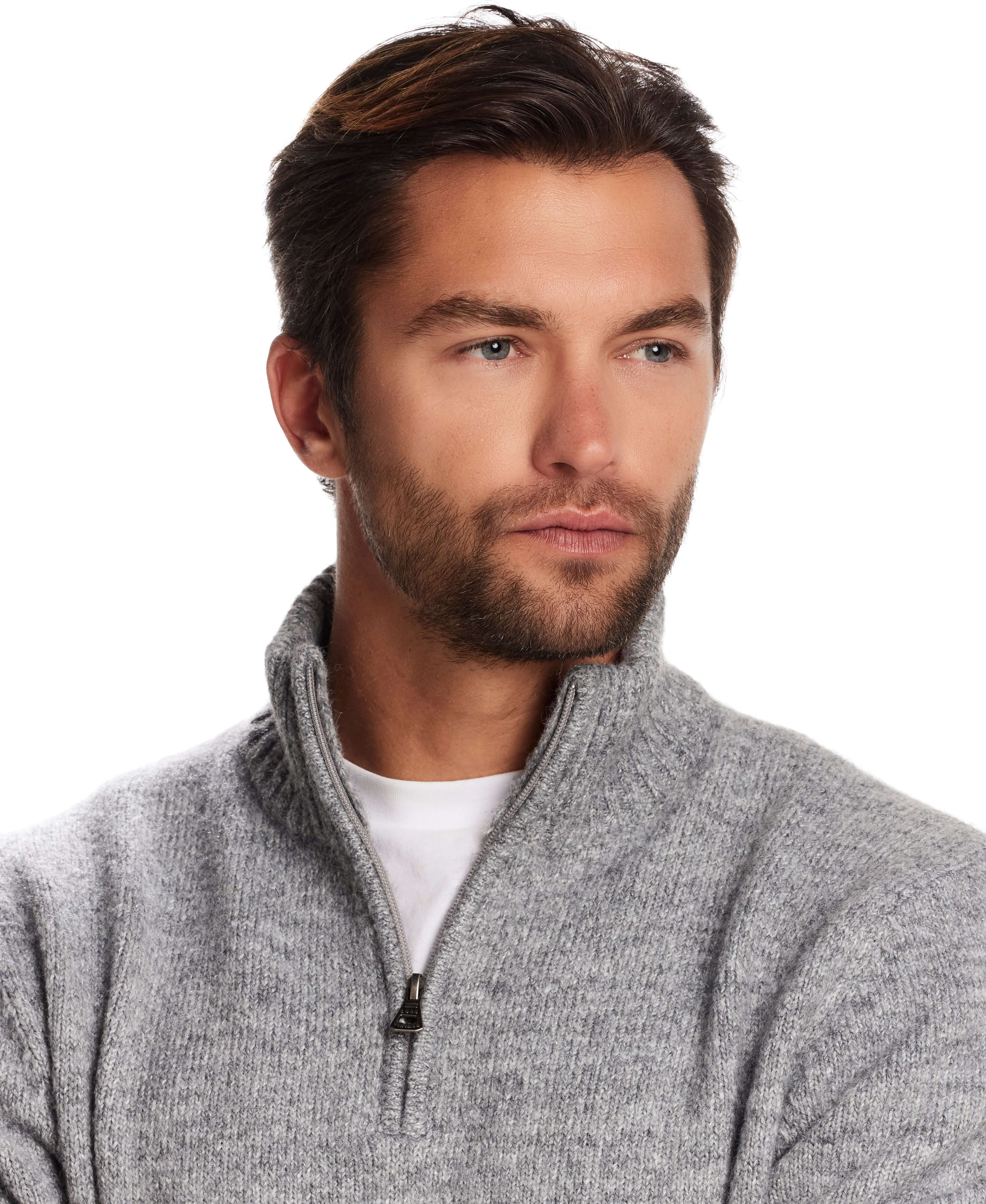 Man wearing a fuzzy quarter zip sweater in grey with a mock neck, showcasing a modern alpine layering style.