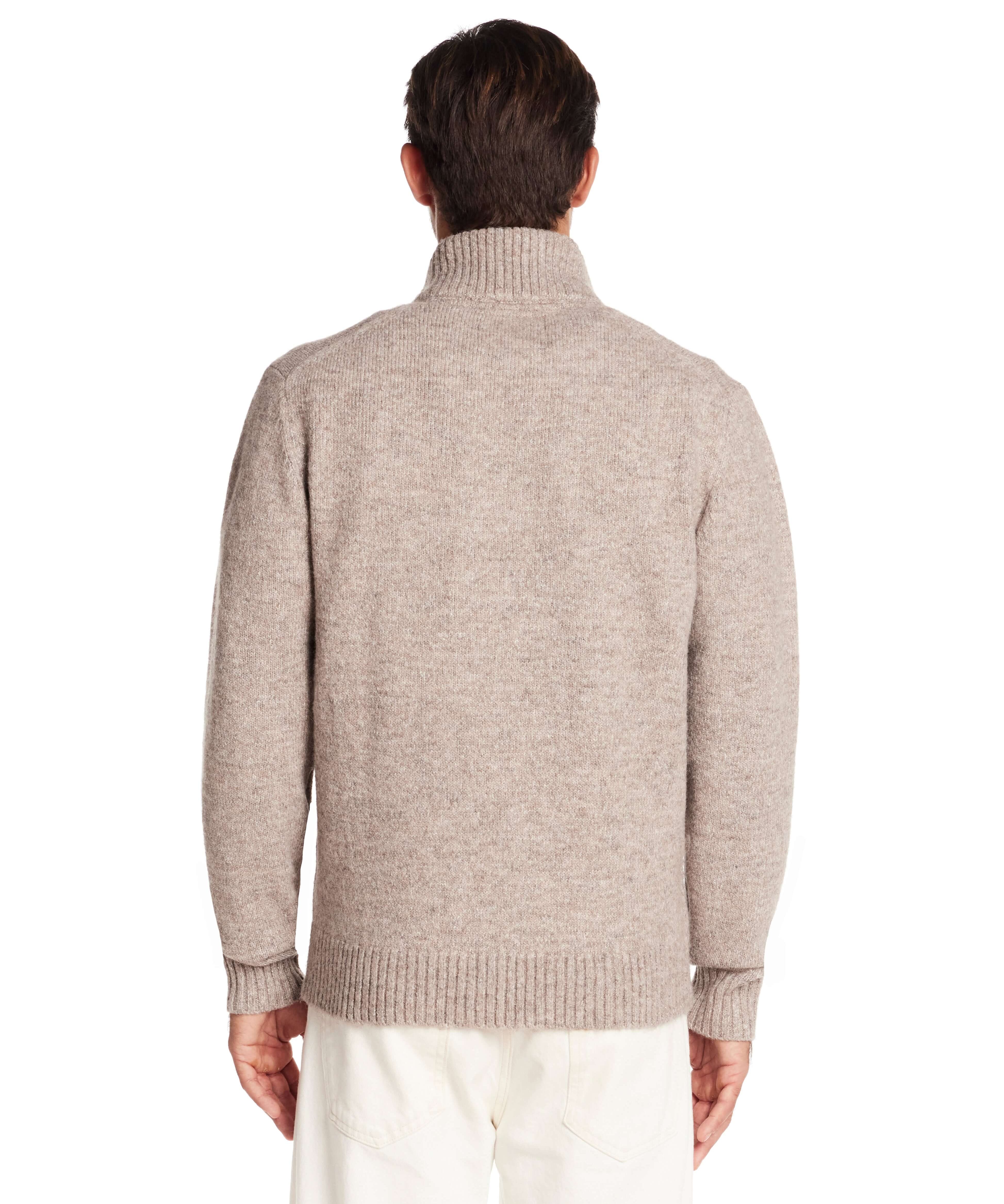 Back view of a man wearing a taupe fuzzy quarter zip sweater with a mock neck and ribbed hem.