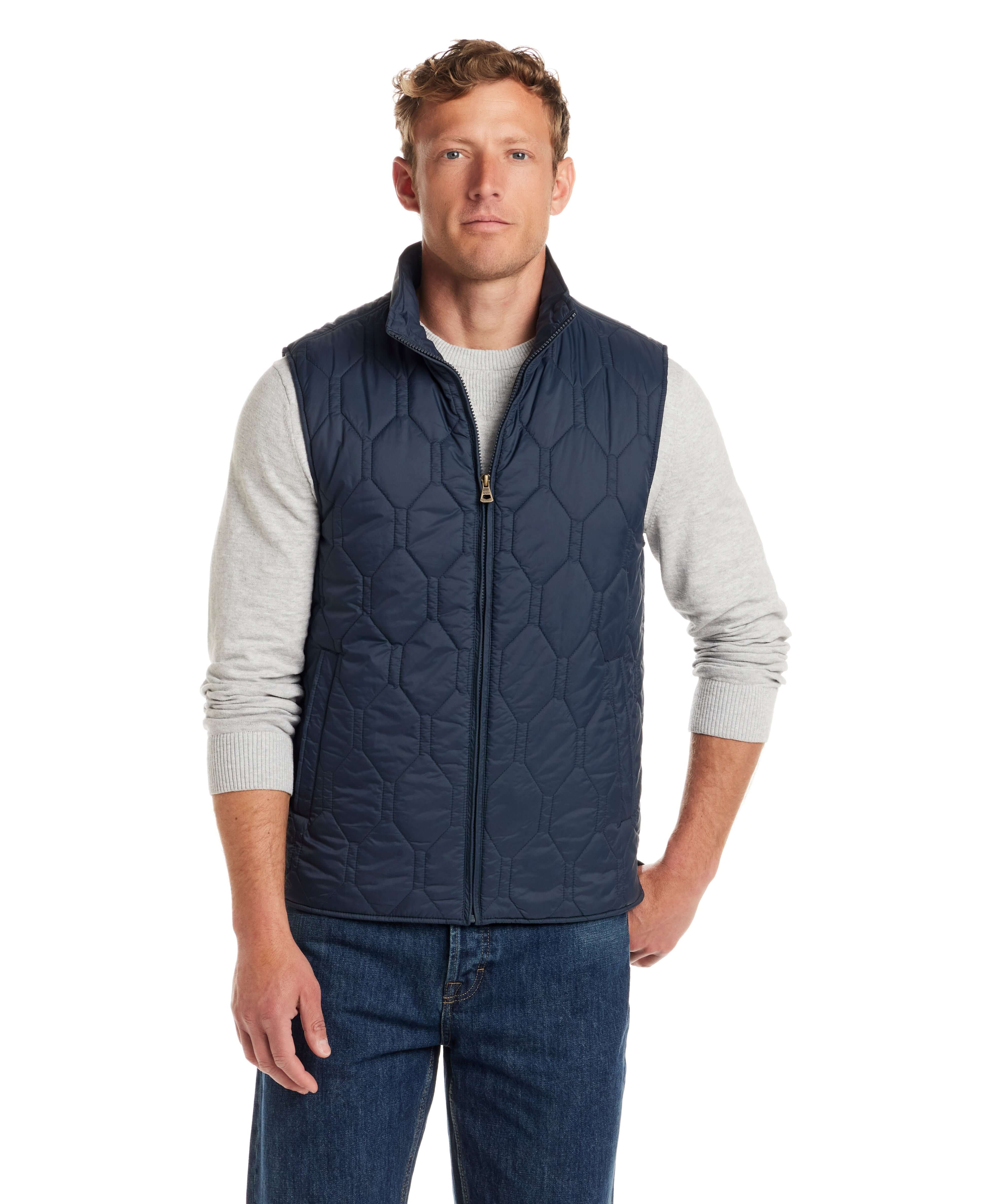 Hexagon quilted lightweight vest in slate blue, featuring front zipper, mock-neck, and side pockets, worn by male model.