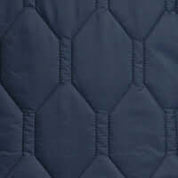 Close-up of hexagon quilted texture in slate blue nylon, showcasing rugged charm and lightweight material.