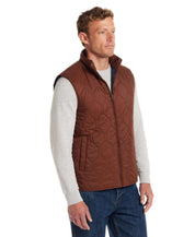 Man wearing a Hexagon Quilted Lightweight Vest in Cappuccino, showcasing a classic design and front zipper closure.