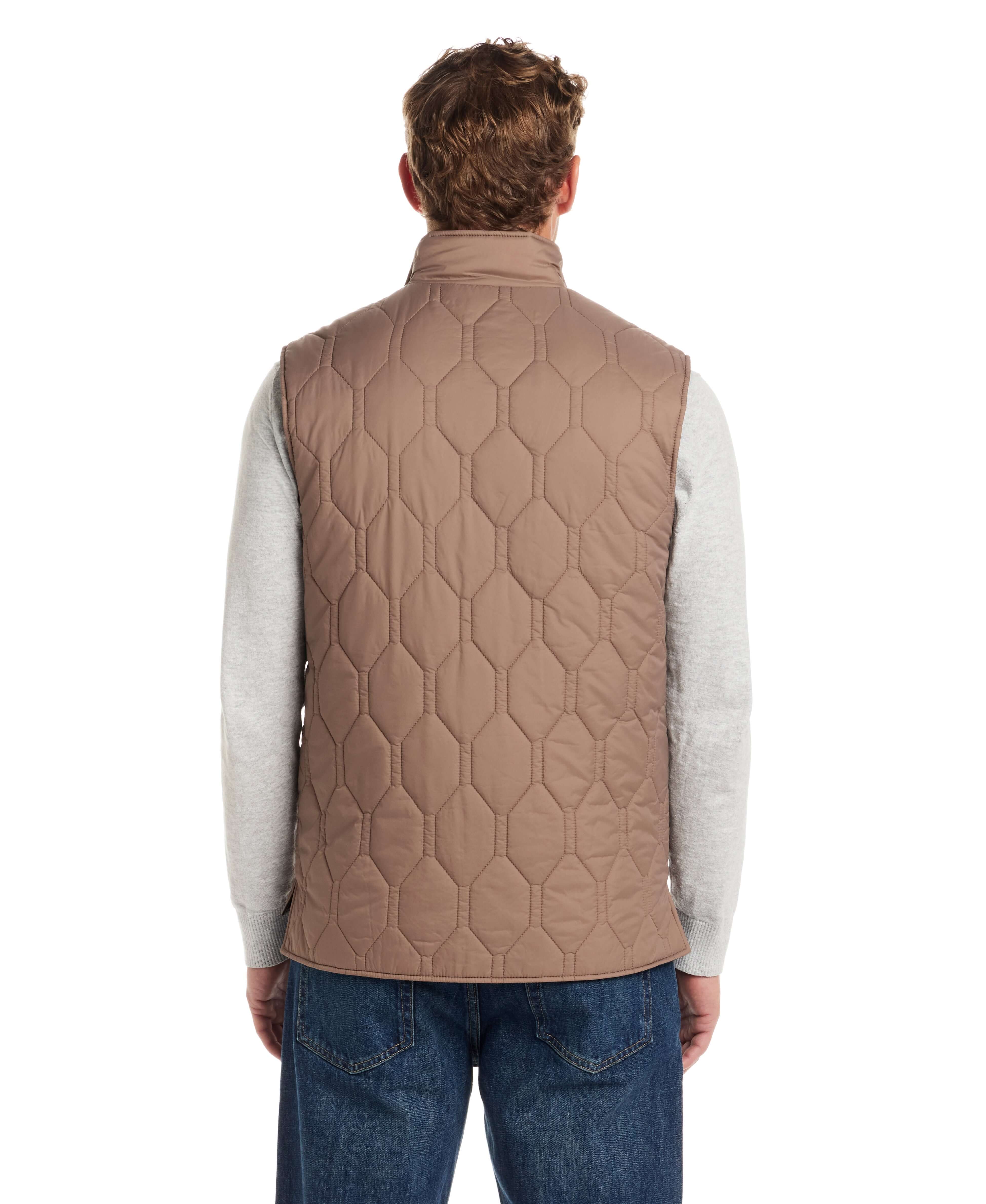 Back view of a man wearing a Hexagon Quilted Lightweight Vest in Mountain Trail, showcasing its unique hexagon pattern and mock-neck design.
