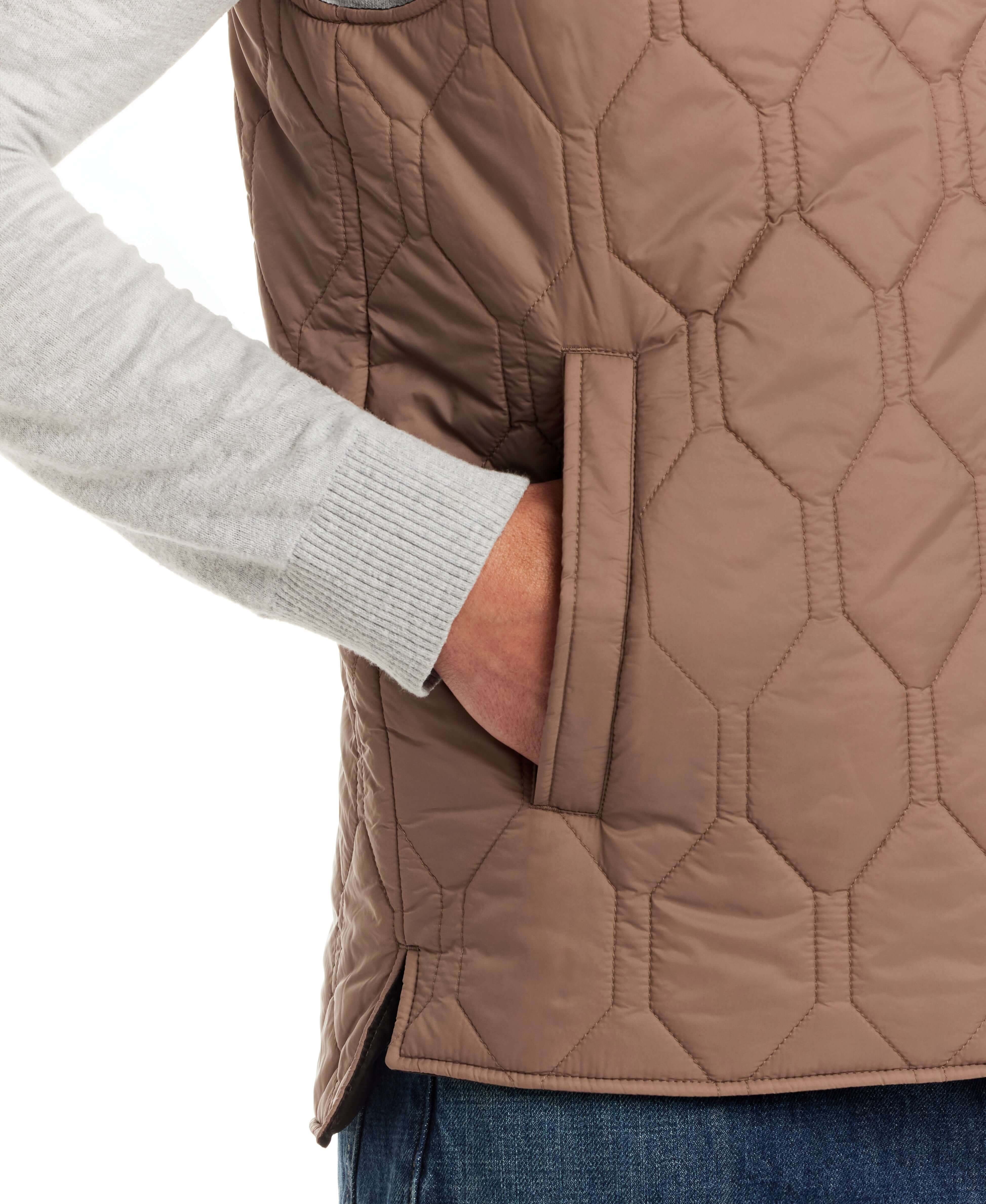 Close-up of Hexagon Quilted Lightweight Vest showing side pocket and textured nylon fabric in a neutral color.