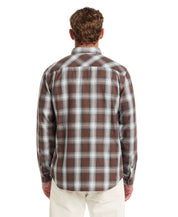Back view of a Long Sleeve Burnout Flannel in Chicory, featuring a classic plaid pattern and buttoned cuffs.