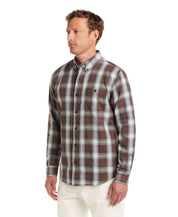 Model wearing Long Sleeve Burnout Flannel in Chicory, featuring plaid design, button-down collar, and chest pocket.