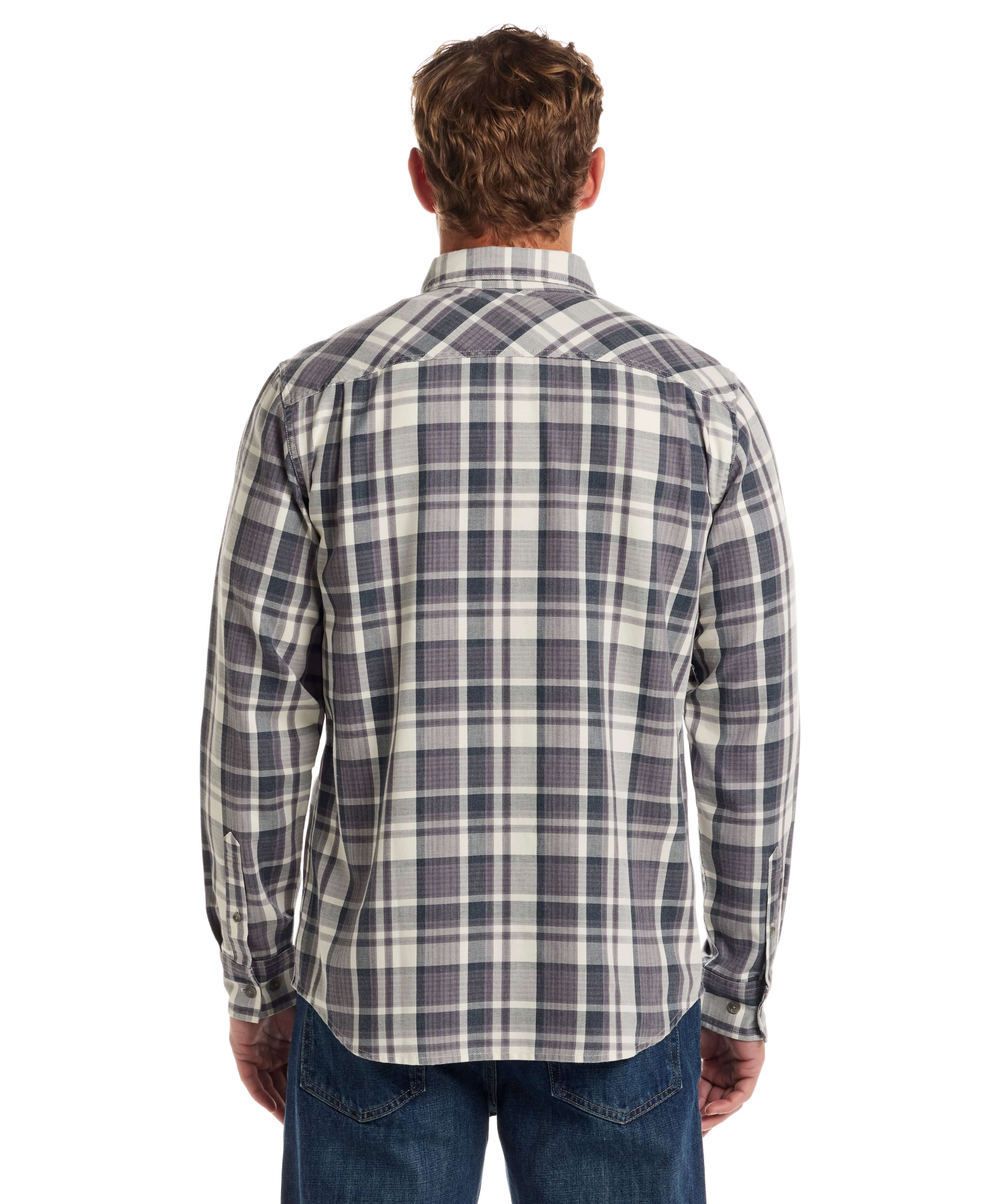 Back view of a man wearing a Long Sleeve Burnout Flannel in Nine Iron, showcasing its classic plaid pattern.