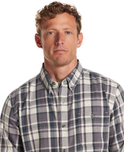 Model wearing Long Sleeve Burnout Flannel in Nine Iron, featuring a weathered plaid design and button down collar.
