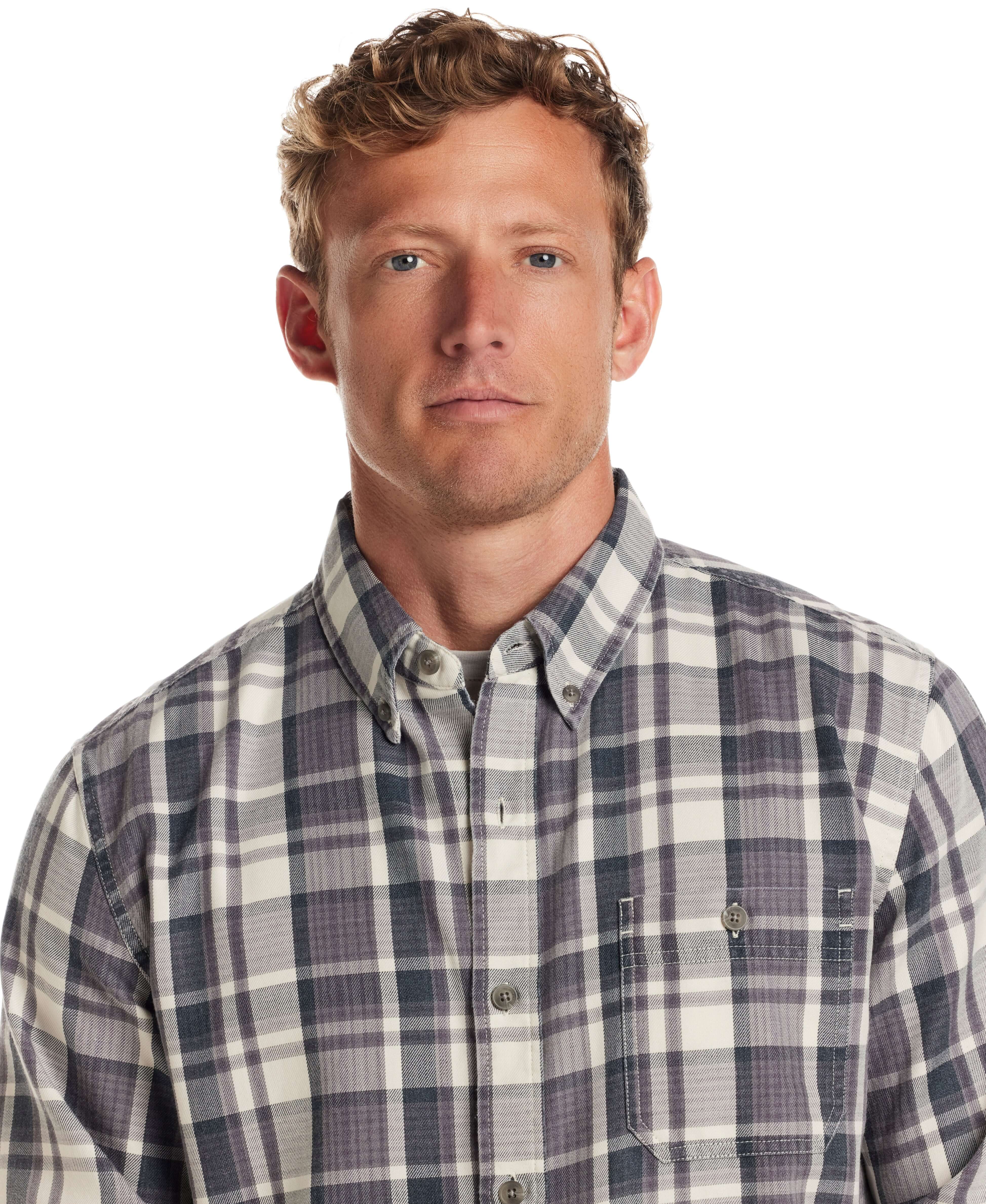 Model wearing Long Sleeve Burnout Flannel in Nine Iron, featuring a weathered plaid design and button down collar.