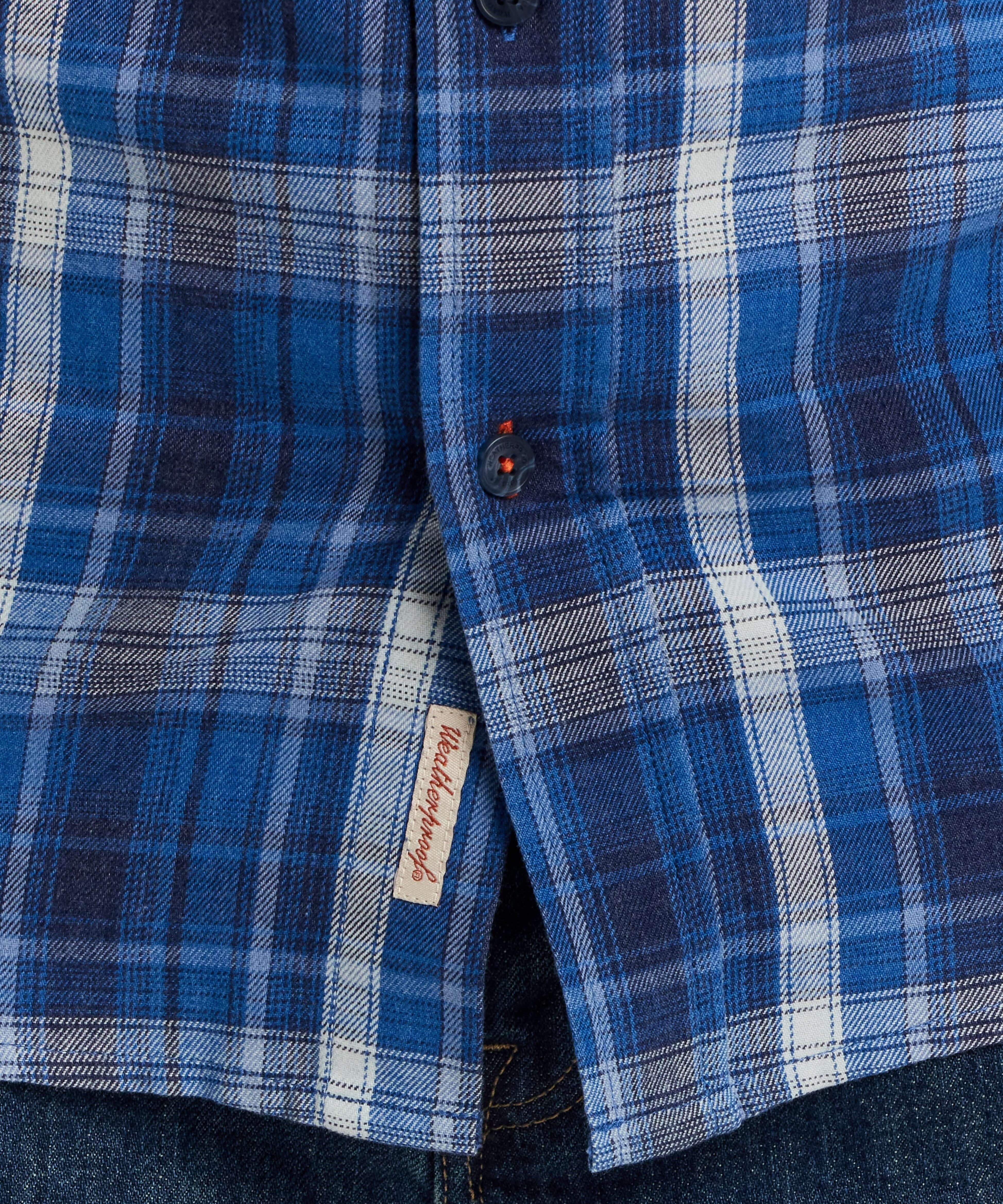 Close-up of Long Sleeve Burnout Flannel shirt in Strong Blue, featuring a classic plaid pattern and button details.