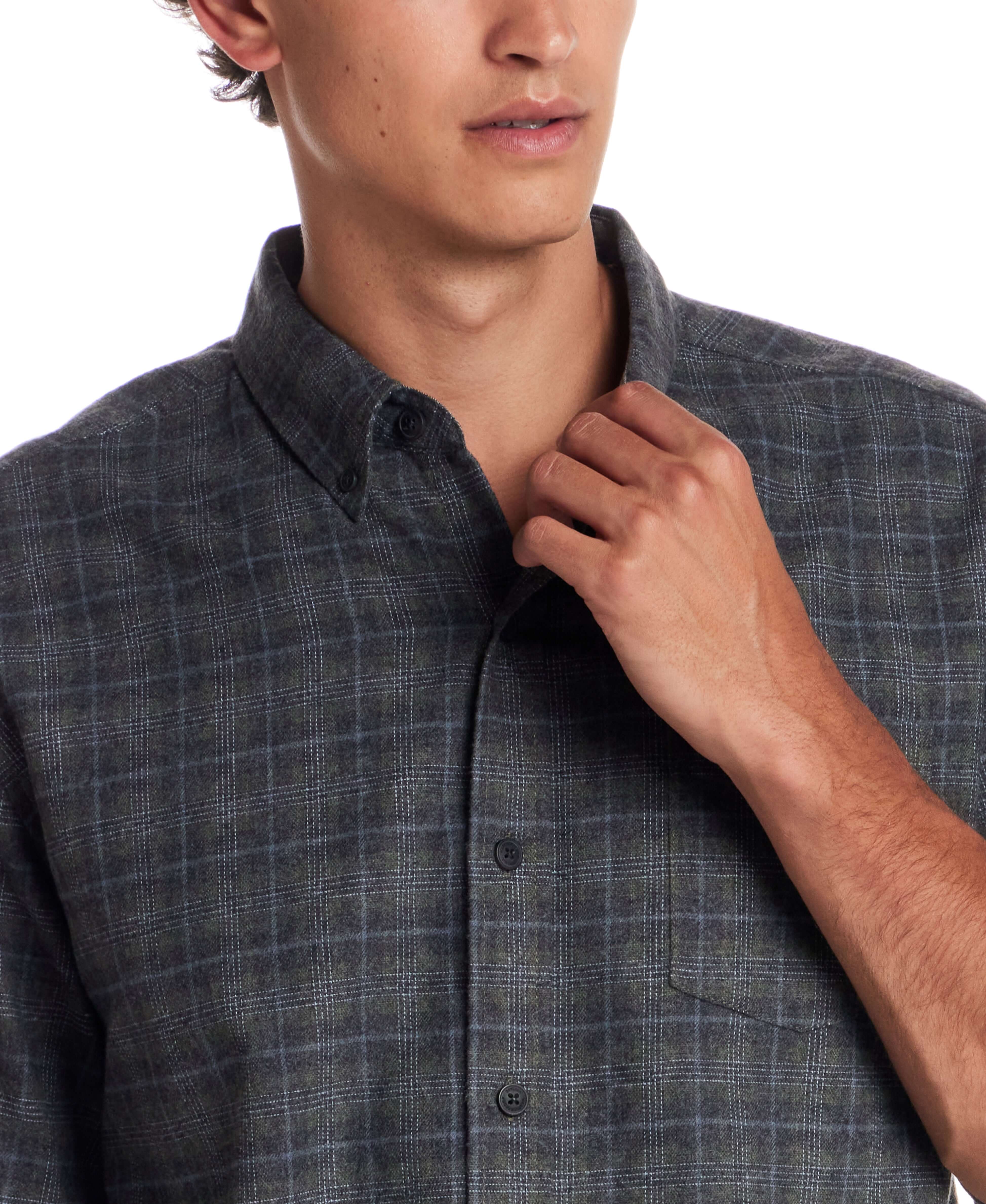 Man wearing a Long Sleeve Brushed Flannel shirt in Winter Moss, highlighting its classic button-down style.