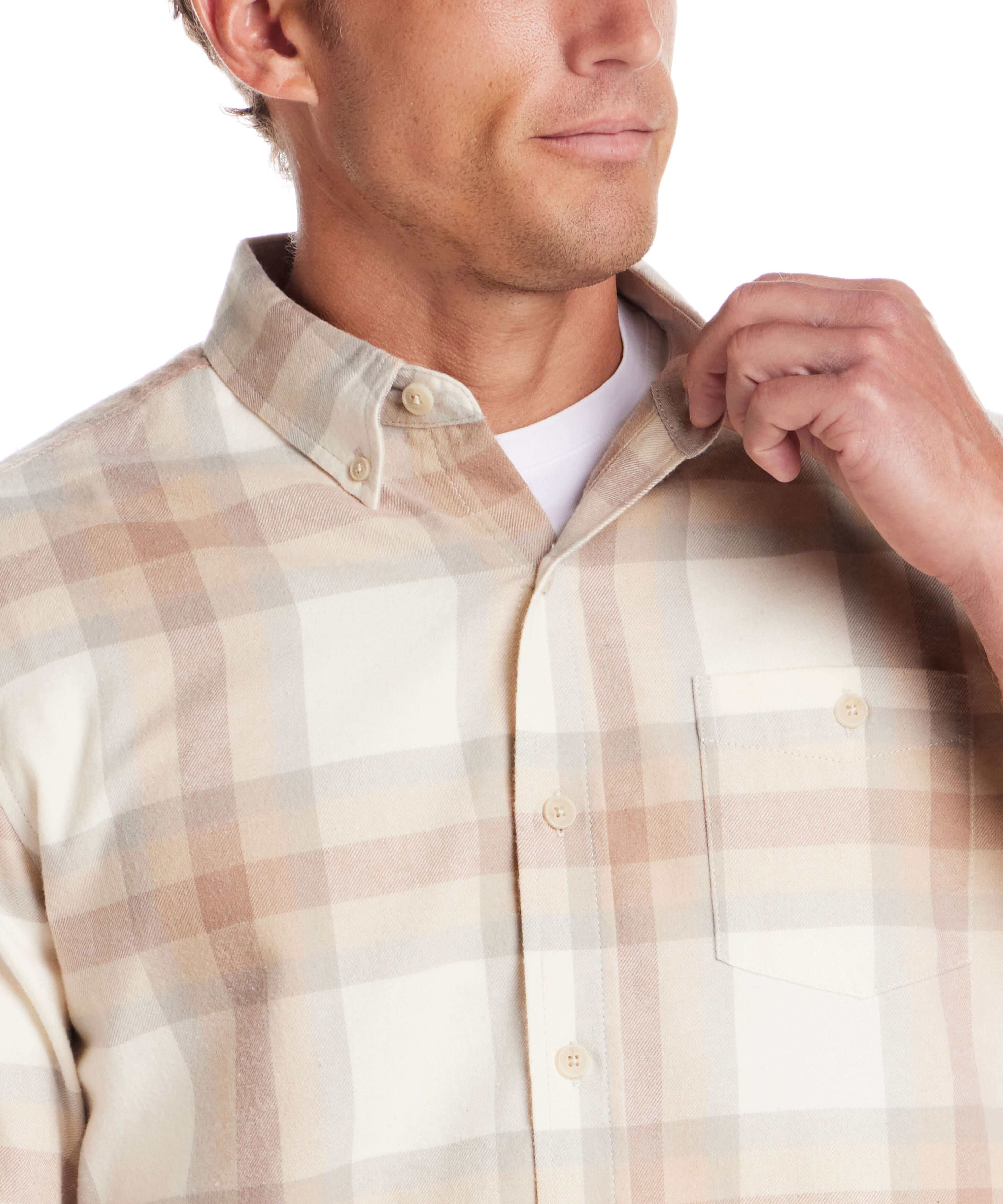 Close-up of a man adjusting the collar of a long sleeve brushed flannel shirt in white and beige check pattern.