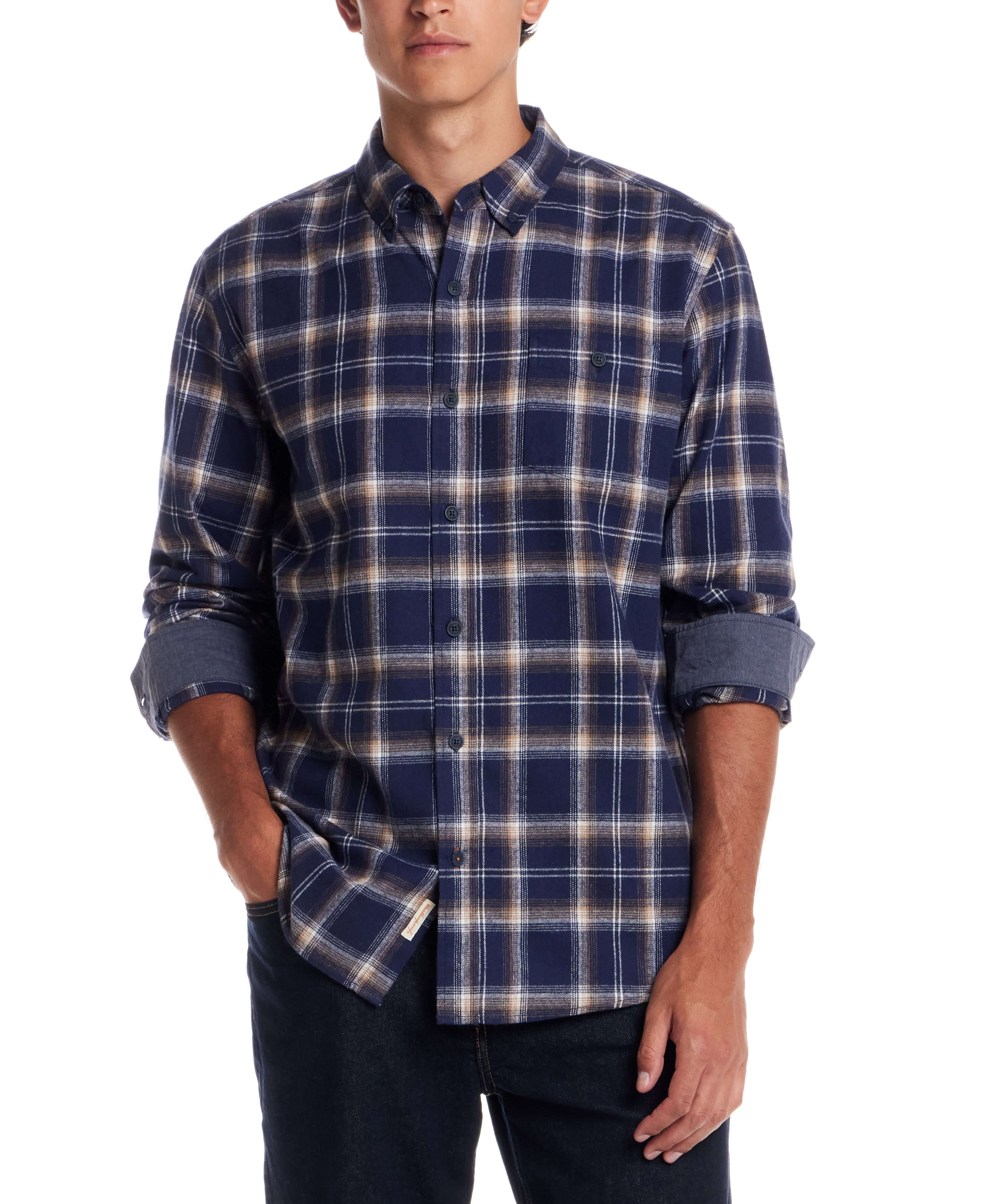 Man wearing a long sleeve brushed flannel shirt in Ocean Cavern, featuring a classic plaid pattern and button-down collar.