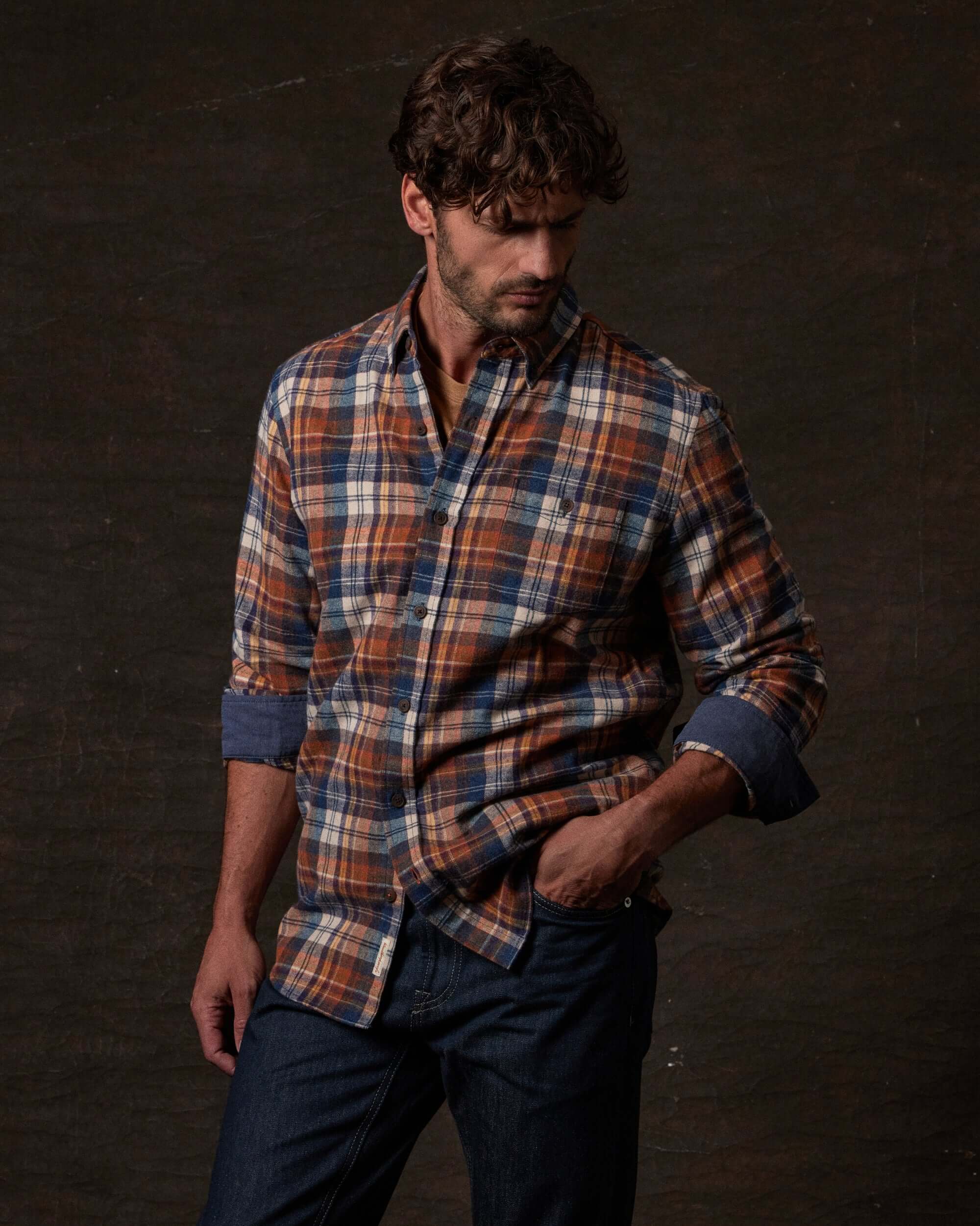 Model wearing a Long Sleeve Brushed Flannel in Umber with checkered pattern and classic fit.