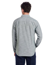 Back view of a man wearing a long sleeve chambray button-down shirt in duck green, showcasing the textured fabric.