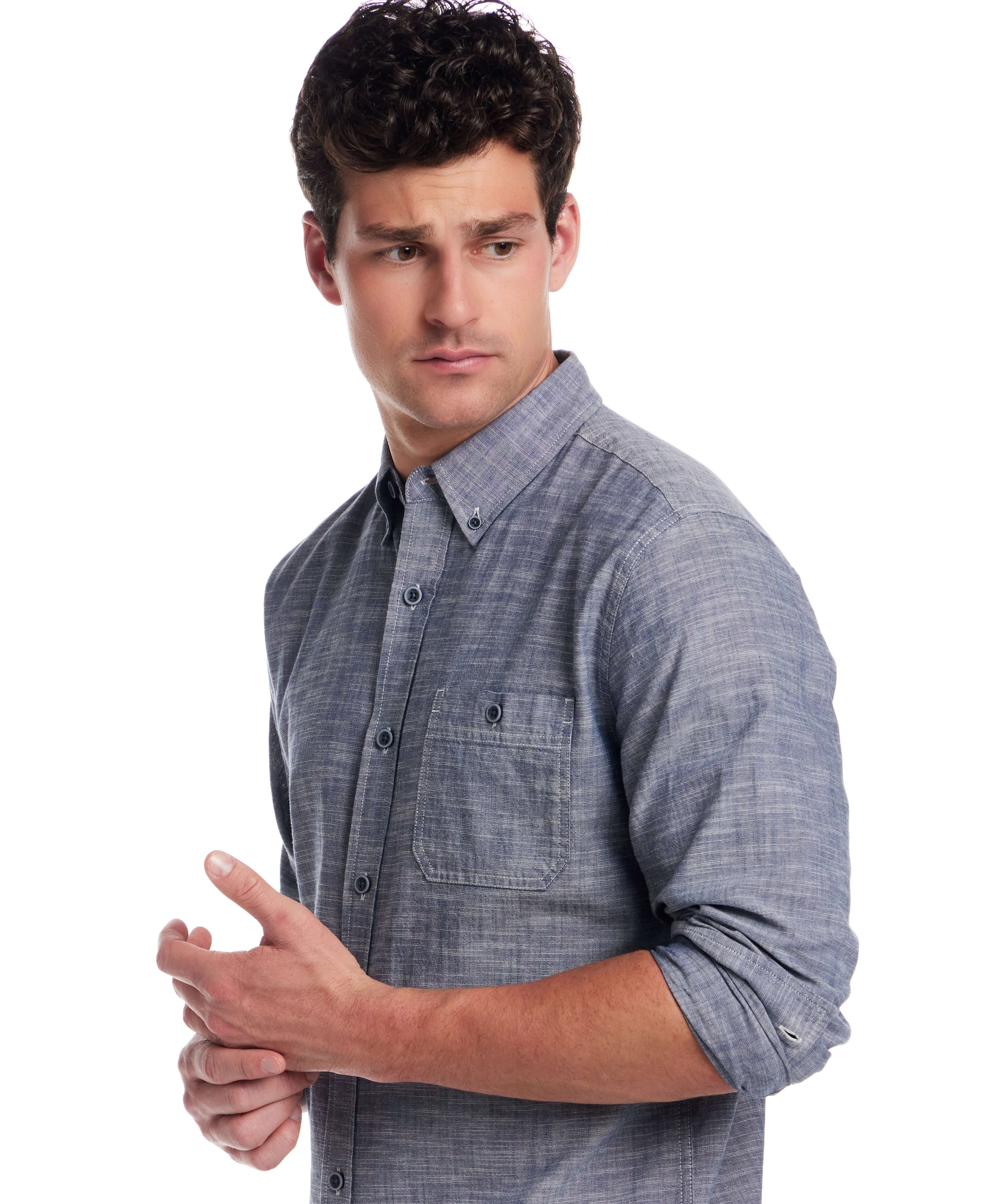 Man in long sleeve chambray button-down shirt, features button-down collar and chest pocket, perfect for versatile styling.
