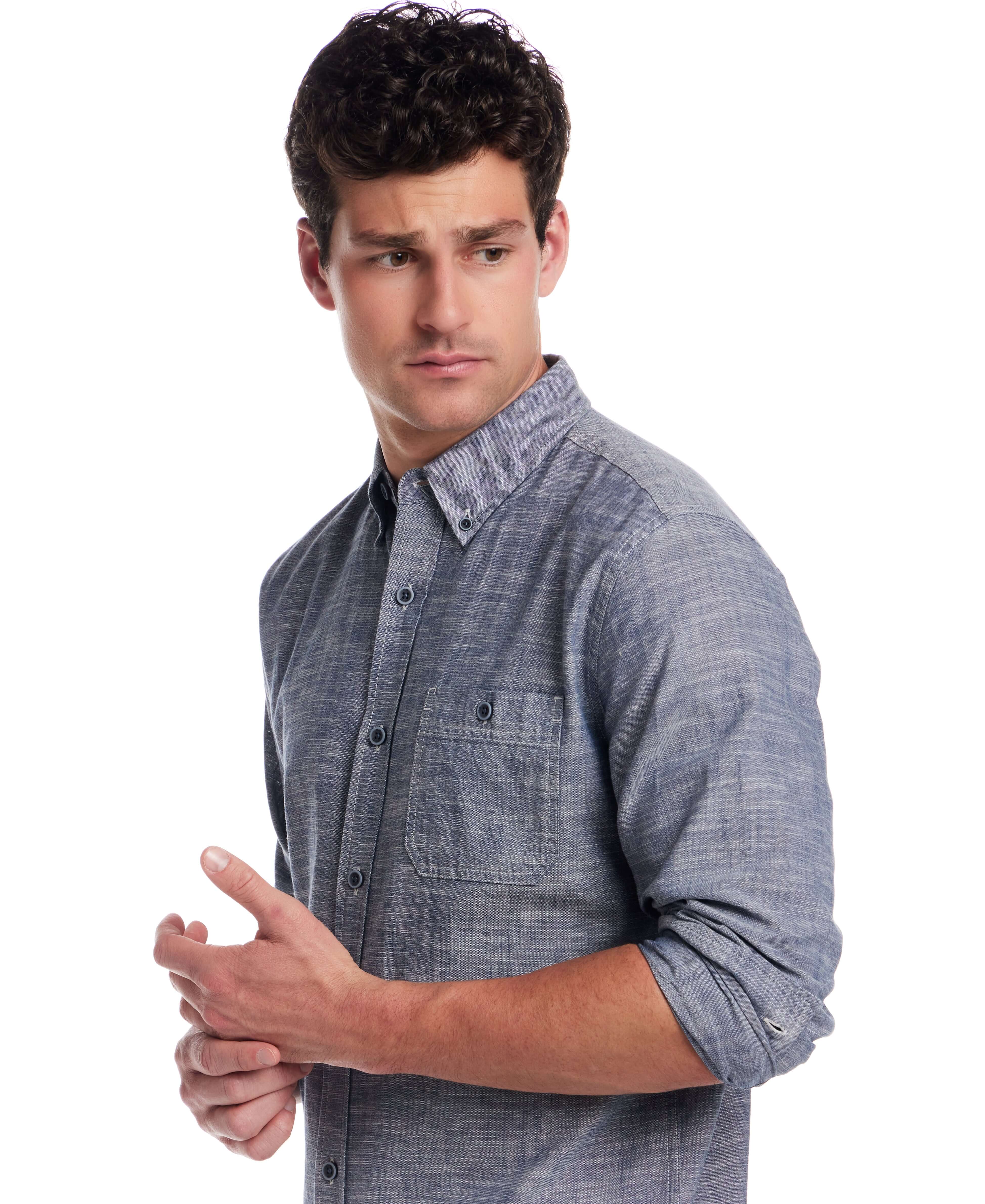 Man in long sleeve chambray button-down shirt, features button-down collar and chest pocket, perfect for versatile styling.