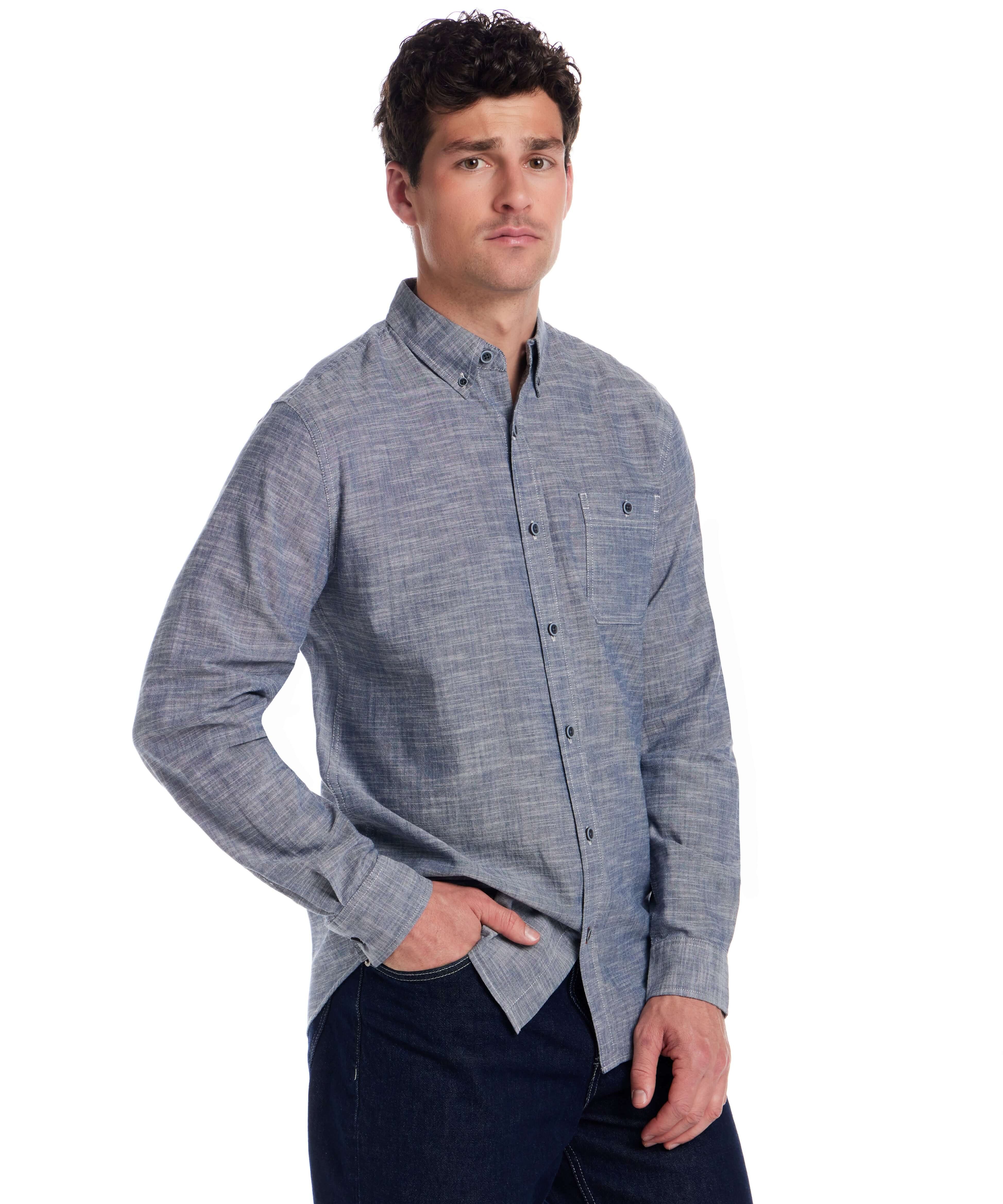 Model wearing a Long Sleeve Chambray Button-Down shirt in Insignia Blue, featuring a button-down collar and chest pocket.