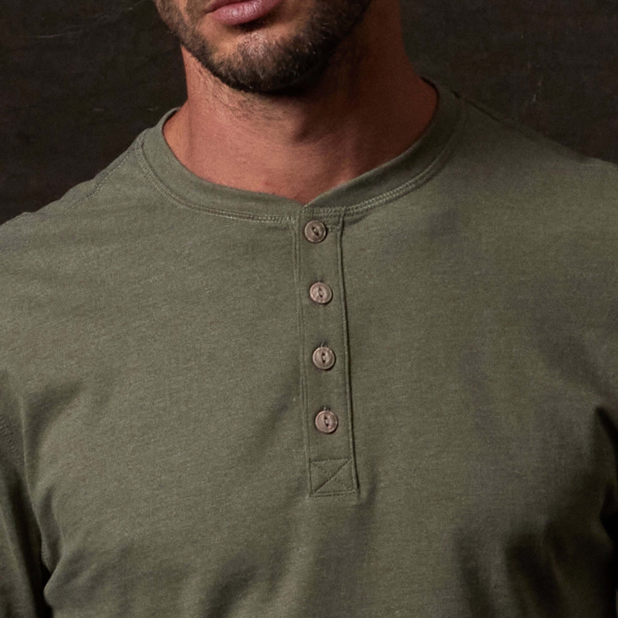 Long Sleeve Brushed Jersey Henley in Olive features a classic henley style and buttons, ideal for year-round wear.