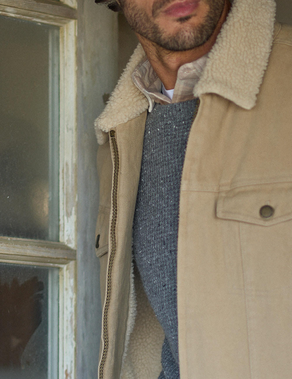 Man wearing a Sherpa Lined Canvas Twill Trucker in White Pepper, showcasing its sherpa collar and rugged style.