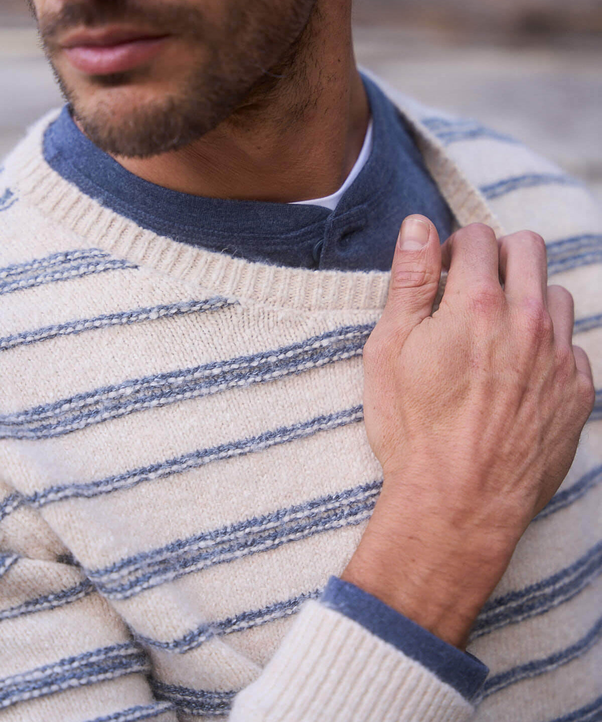 Model wearing a fuzzy striped crew sweater in cream and blue, showcasing casual elegance and vintage-inspired style.